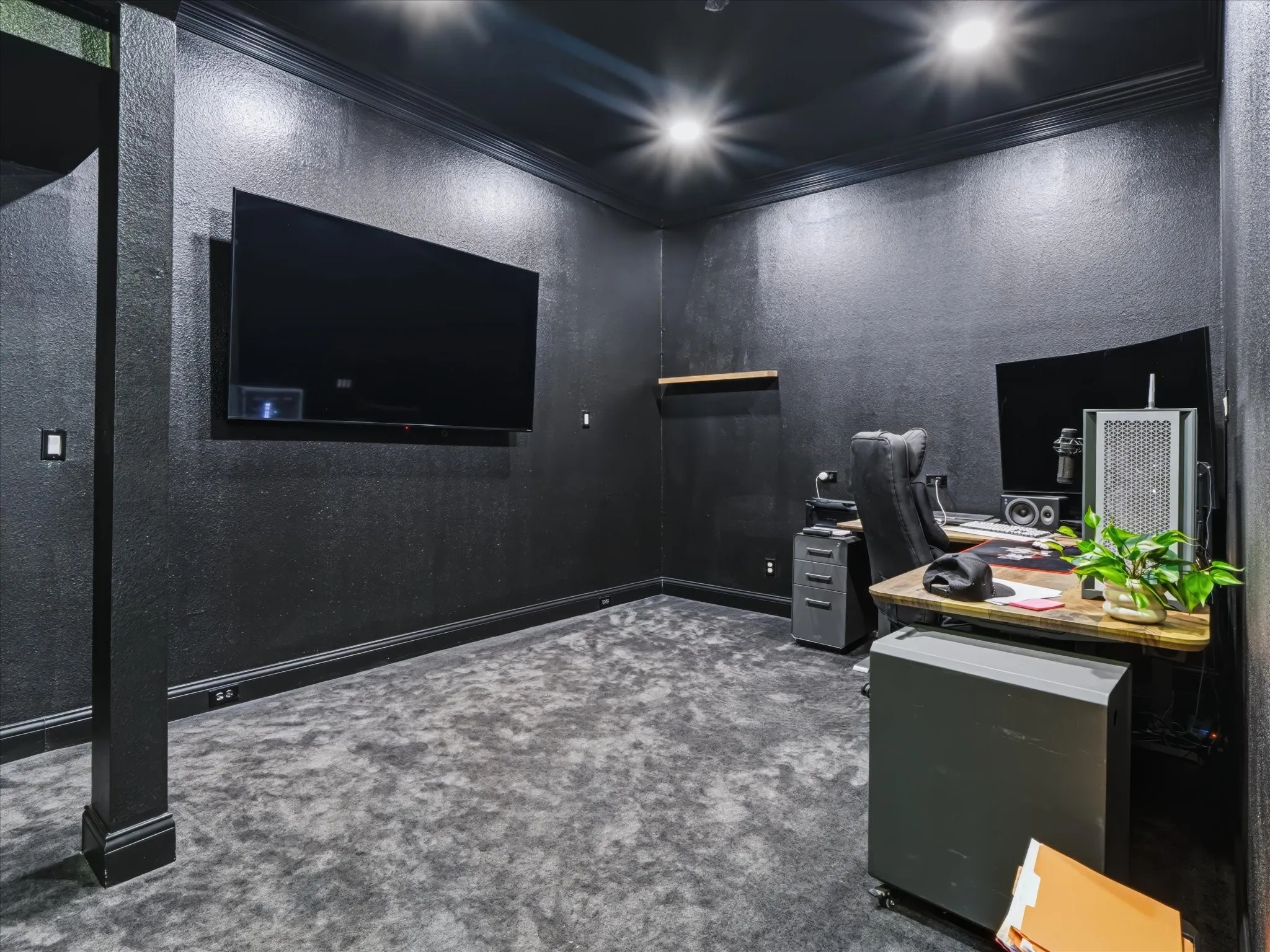Recessed lighting illuminating textured wall finishes, crown molding, and plush carpet flooring