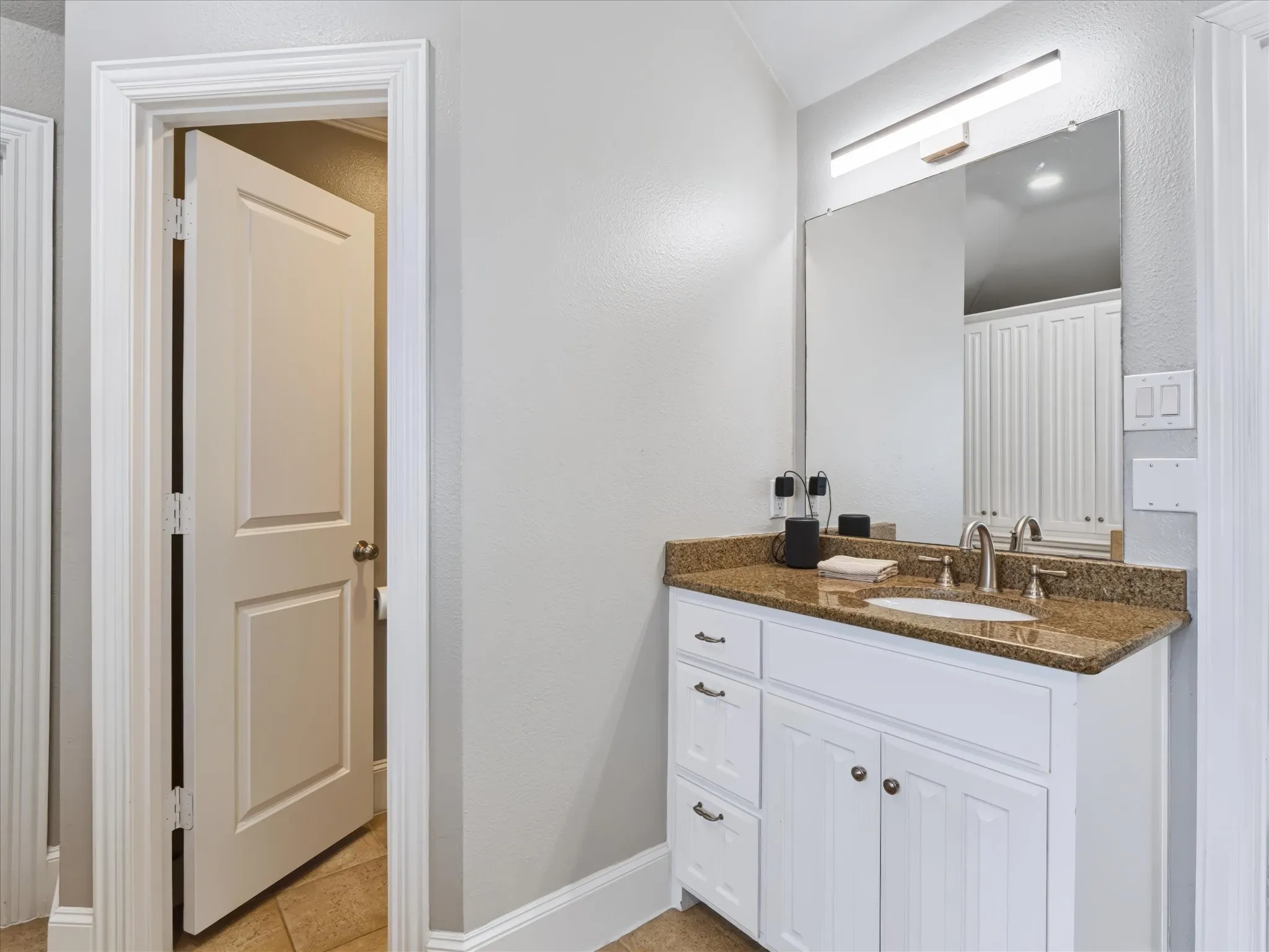 White vanity with storage drawers, undermount sink, and polished chrome faucet