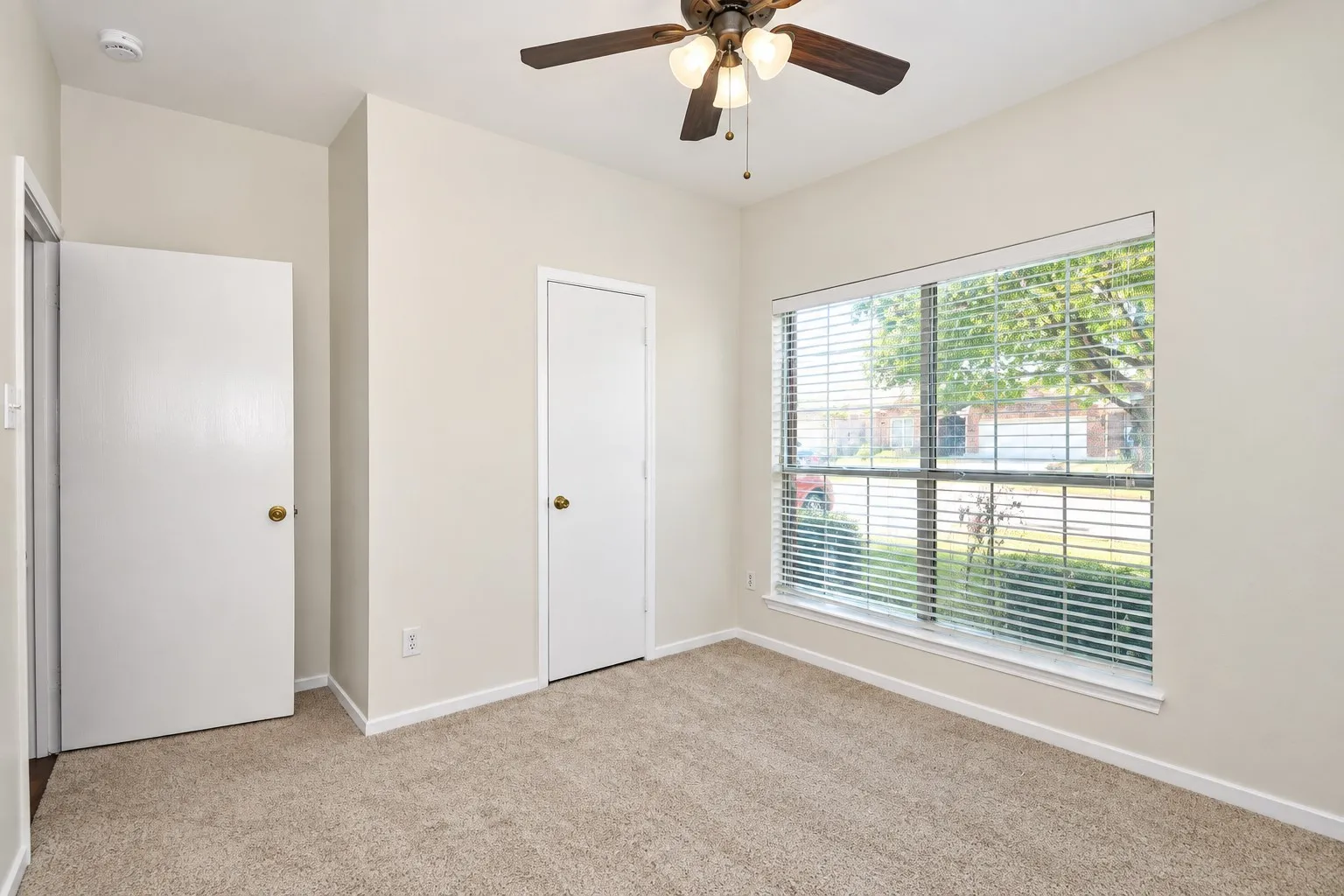 Wall-to-wall carpeting with light neutral paint throughout
