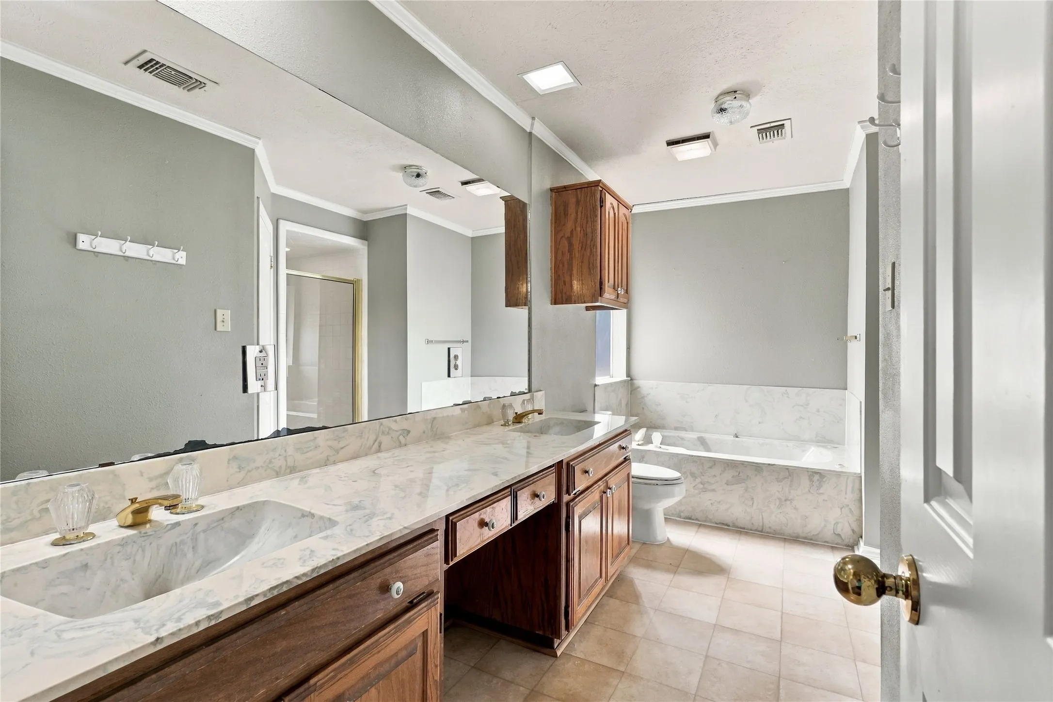 Dual vanity with integrated sinks and gold-tone fixtures