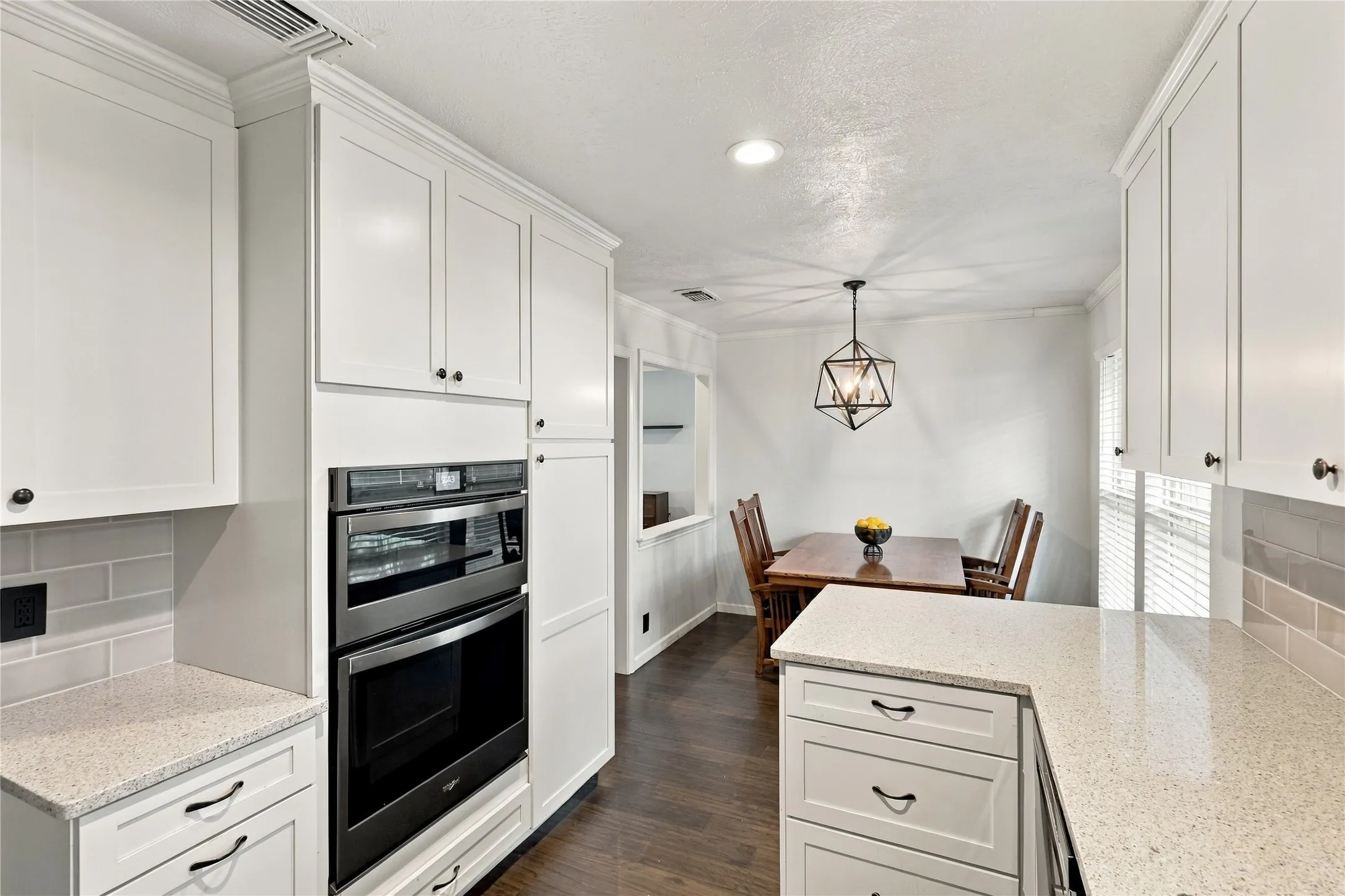 White shaker-style cabinetry with dark hardware
