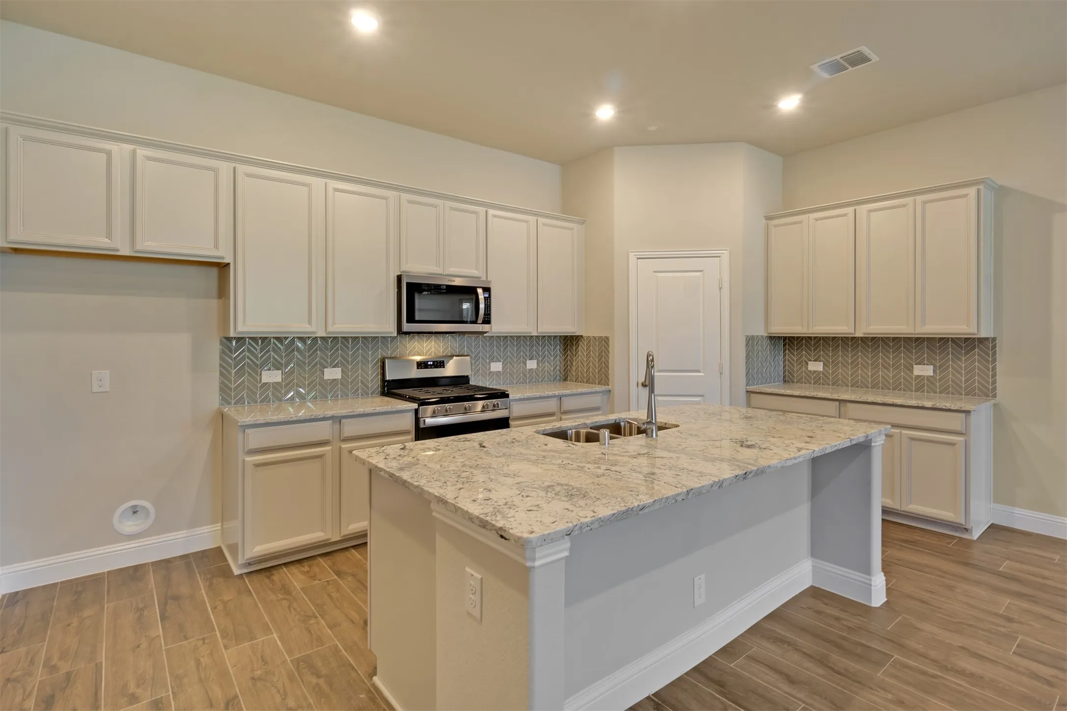 Dream kitchen features center island/breakfast bar, tons of cabinetry and spacious pantry.