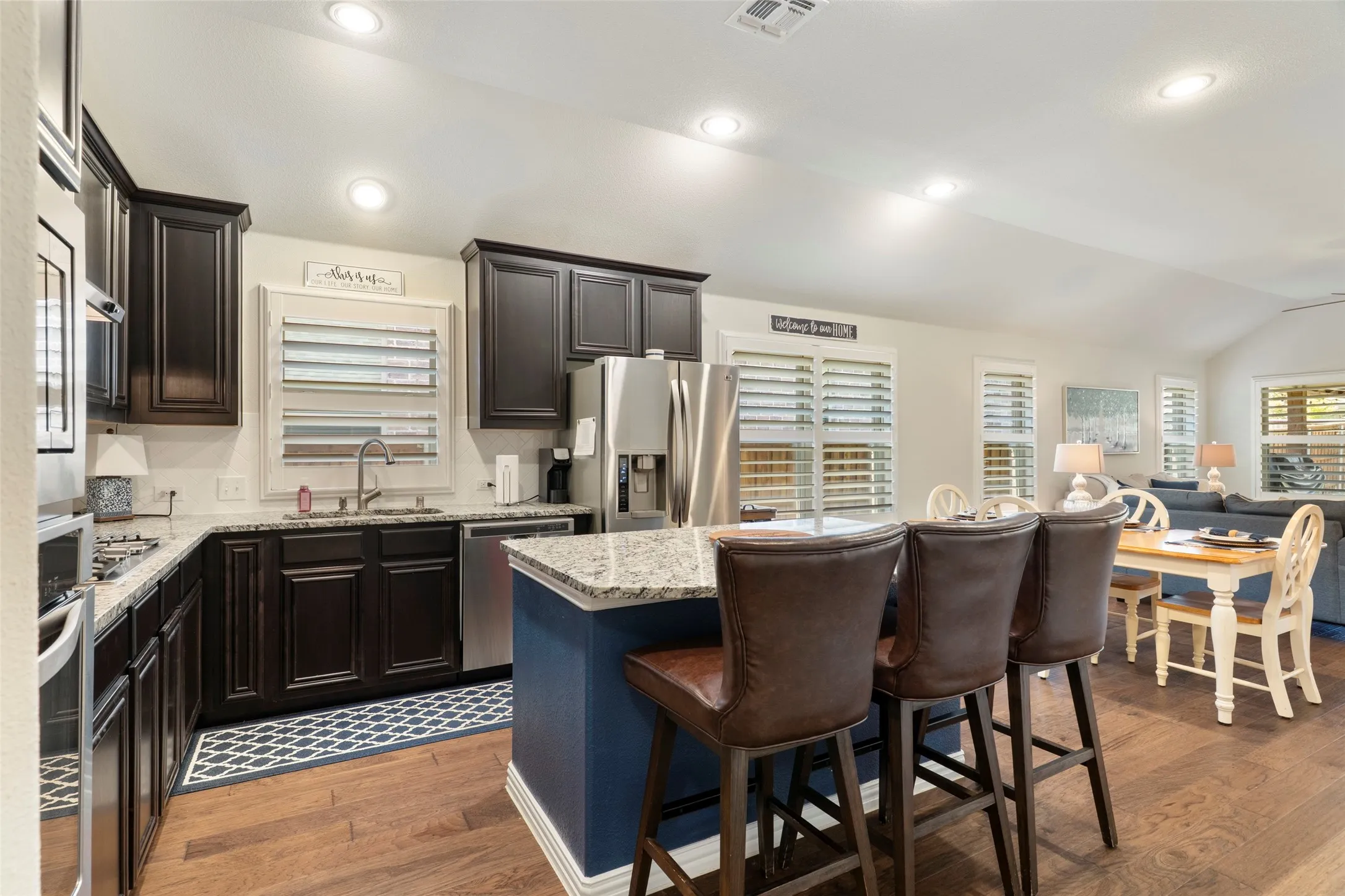 Kitchen with granite countertops, ss appliances, gas cooktop, island and more!