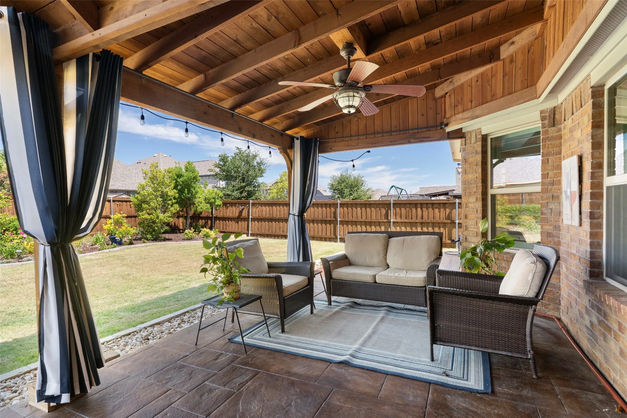 Oversized Covered Patio with lighting and curtains