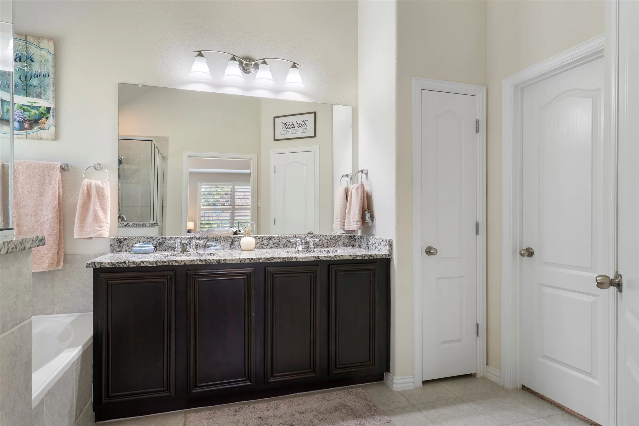 Primary Bath with granite countertops and dual sinks..