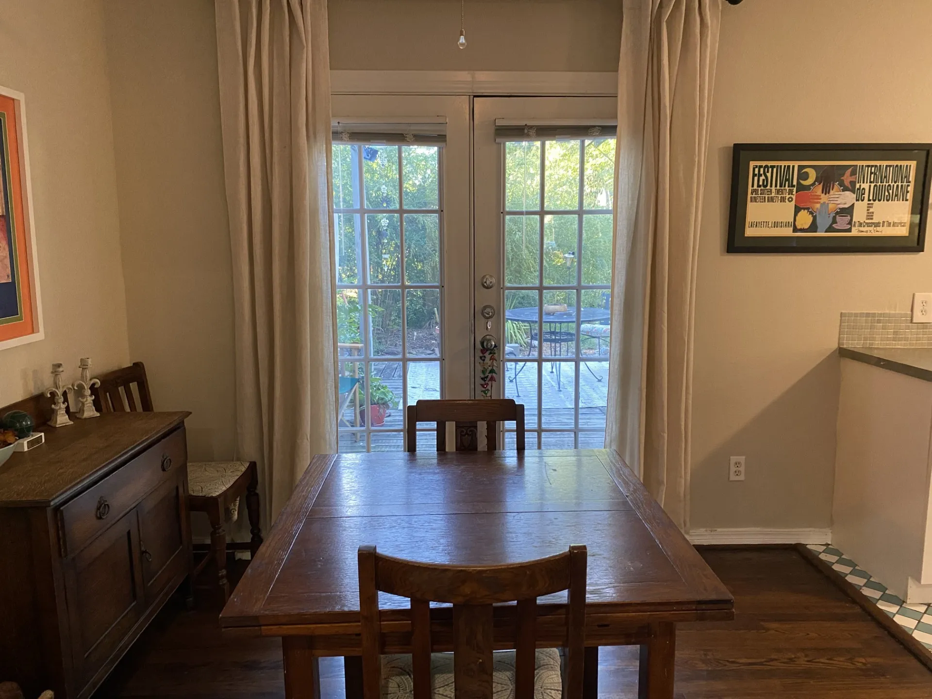 Wood-finish flooring, French doors, and a tiled backsplash