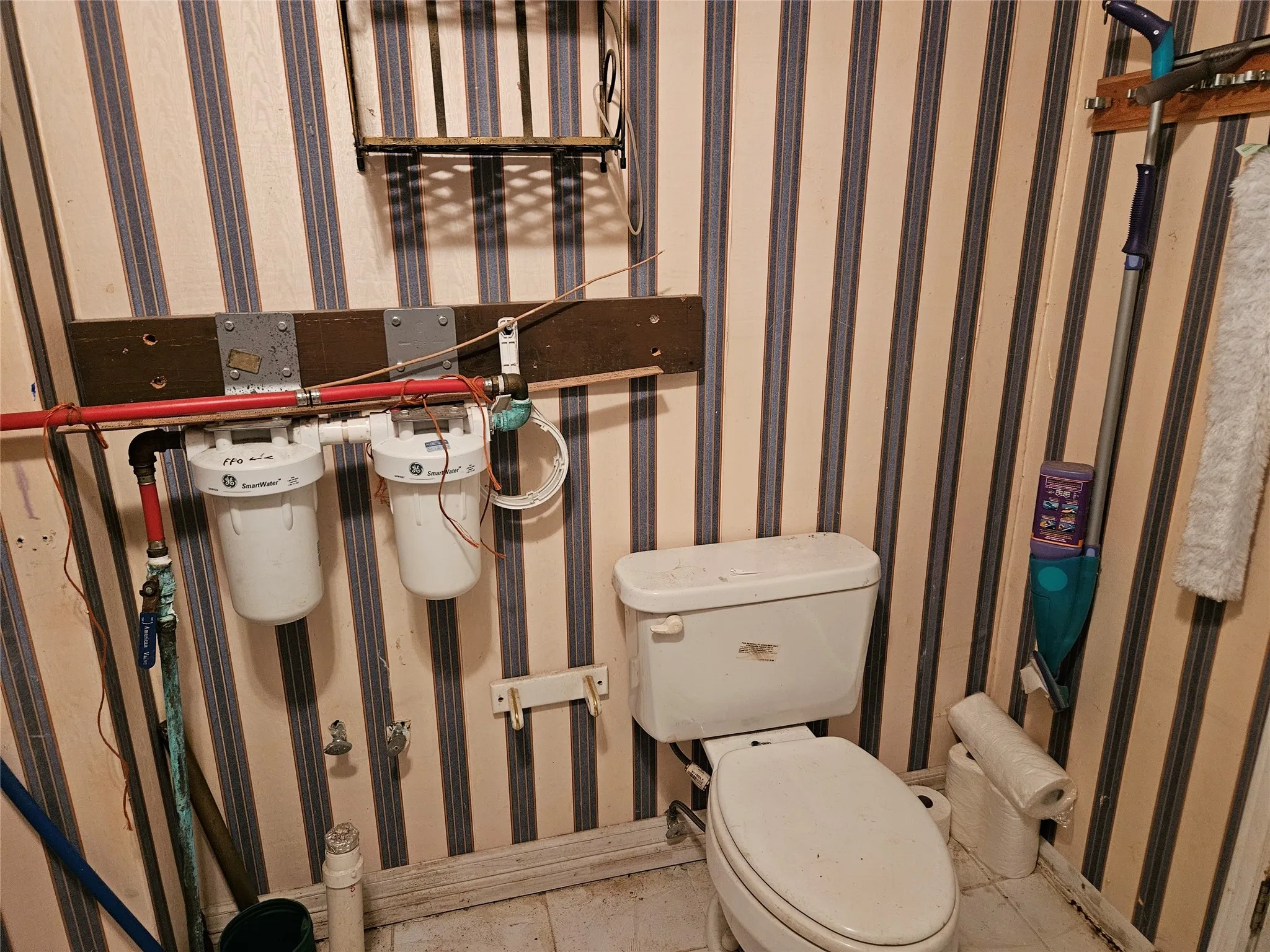 Half bathroom with wallpapered walls