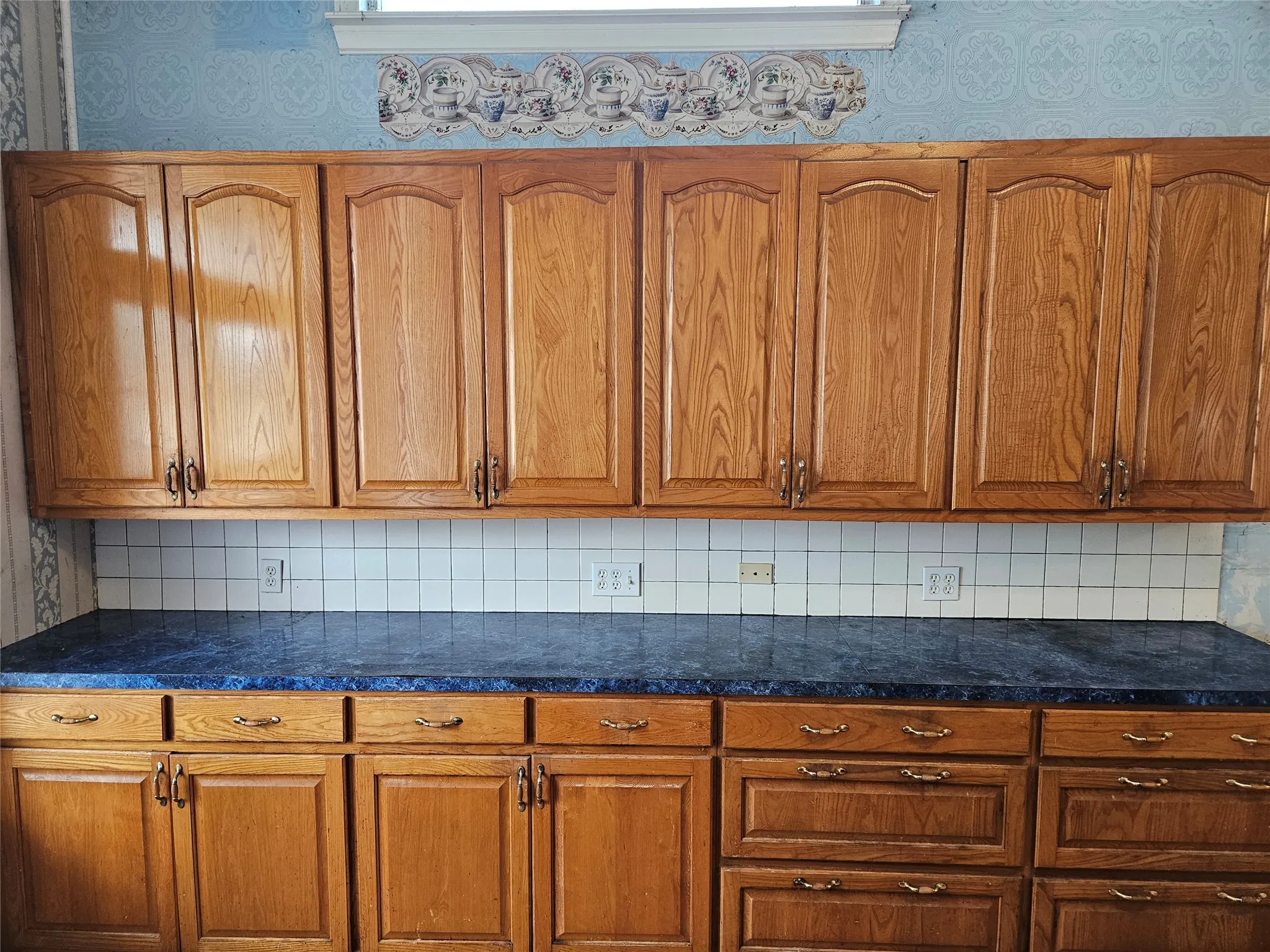 Kitchen featuring backsplash and wood finish cabinets