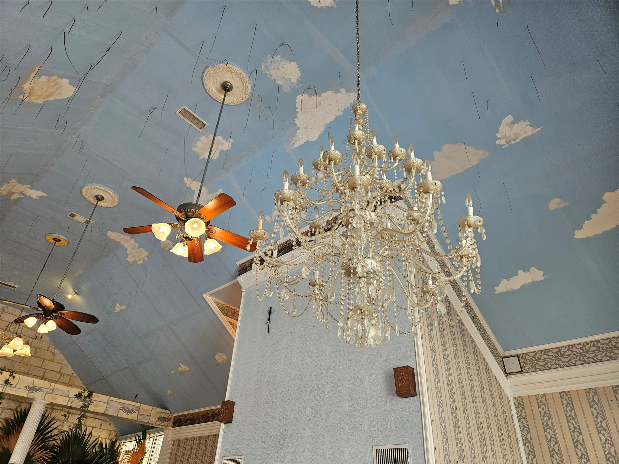 Detailed view of a ceiling fan and suspended lighting