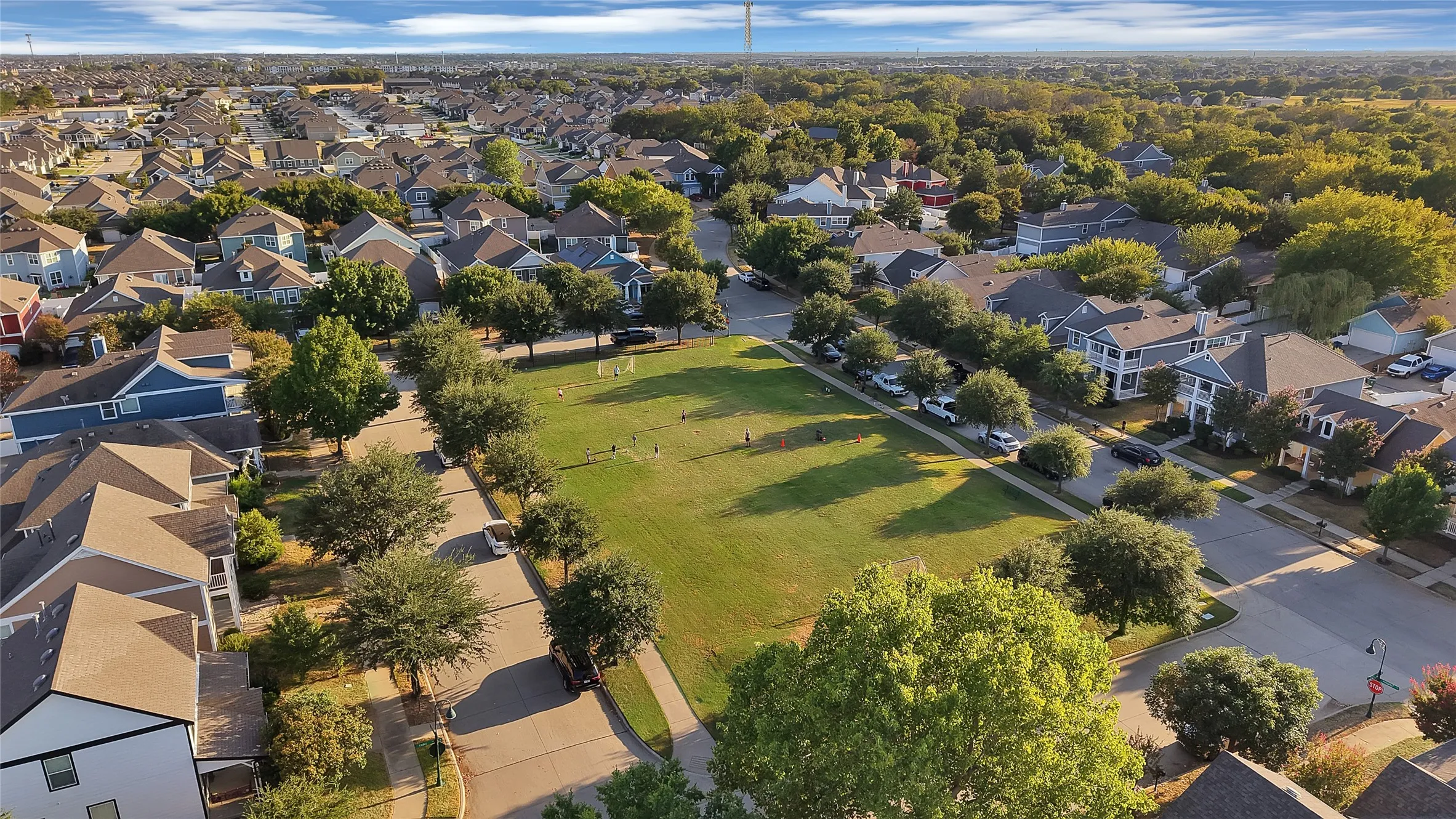 Aerial perspective showcasing a residential community with abundant mature trees and extensive green spaces