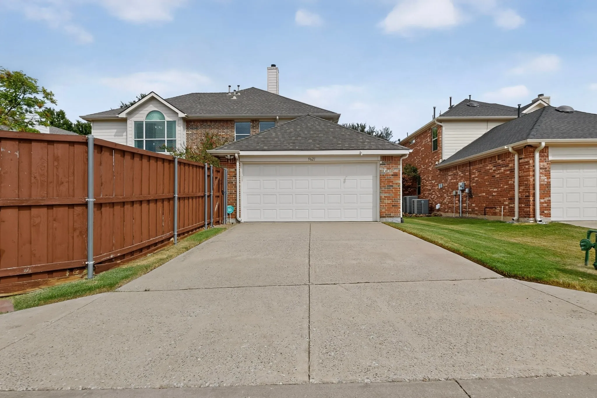 Attached two-car garage with a concrete driveway