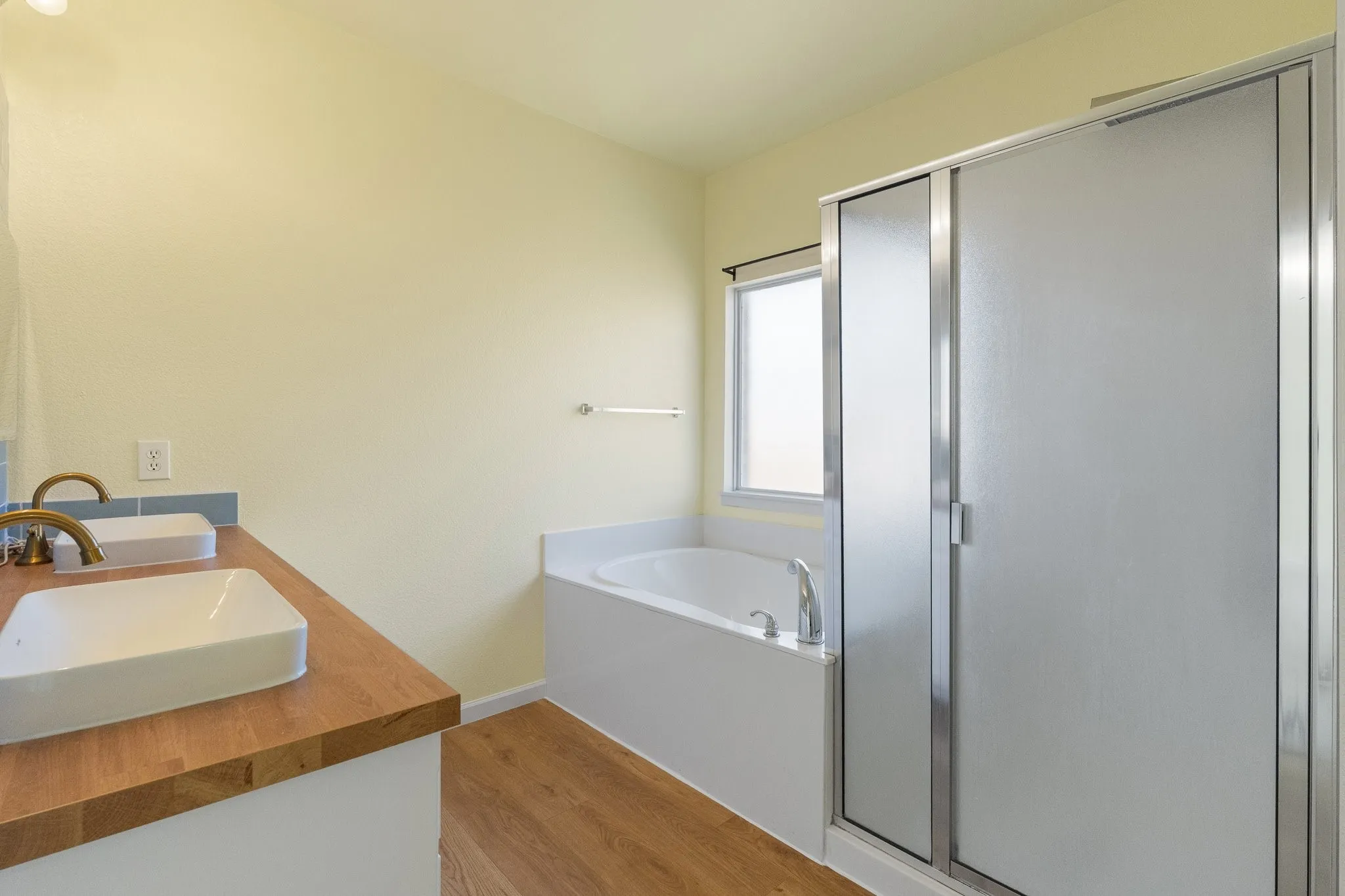 Dual vessel sinks with wood-finish countertop