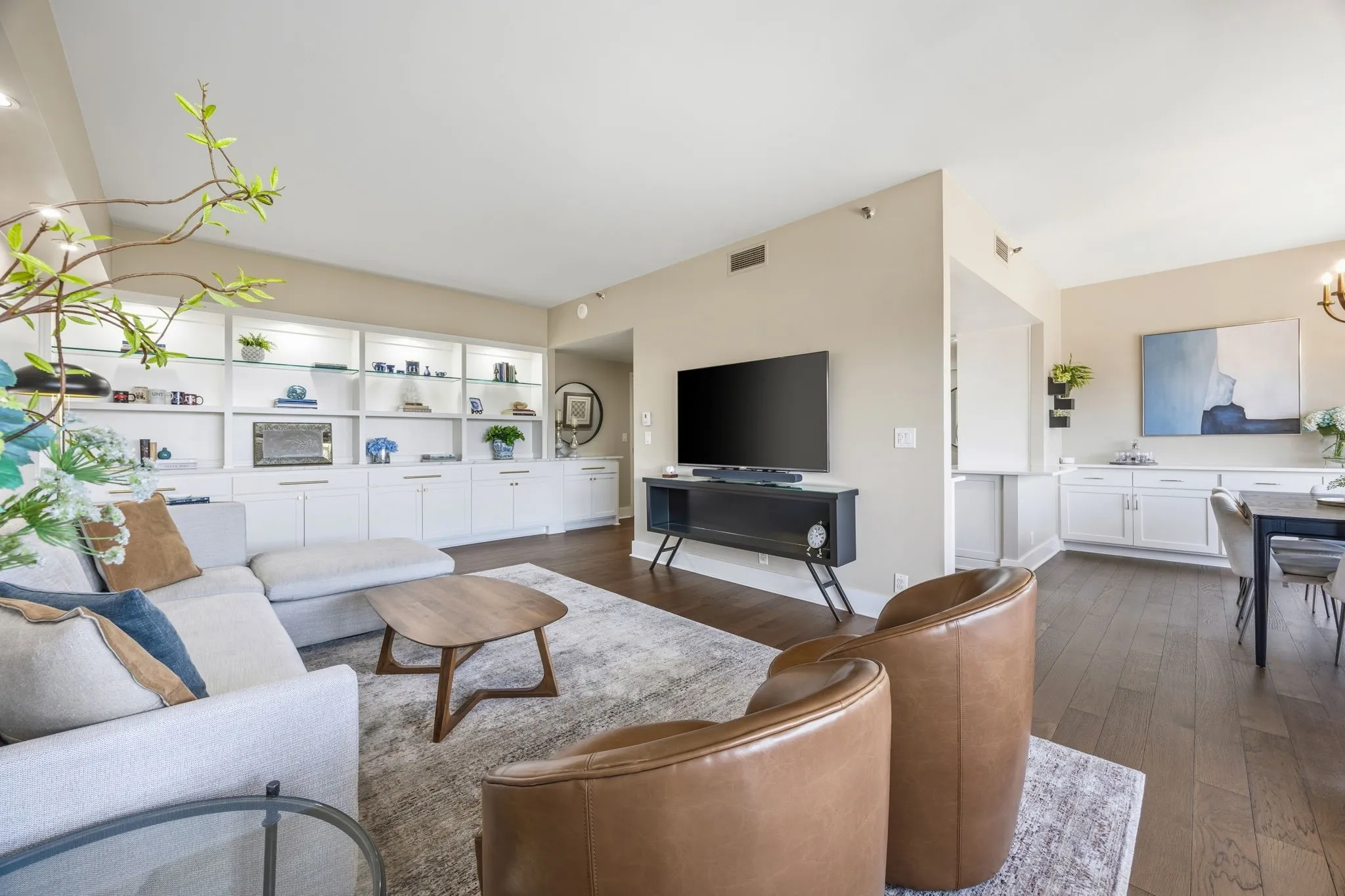 This wider view of the living area highlights its seamless connection to the dining space, with the beautifully updated kitchen conveniently located just steps away, creating an ideal layout for everyday living and entertaining.