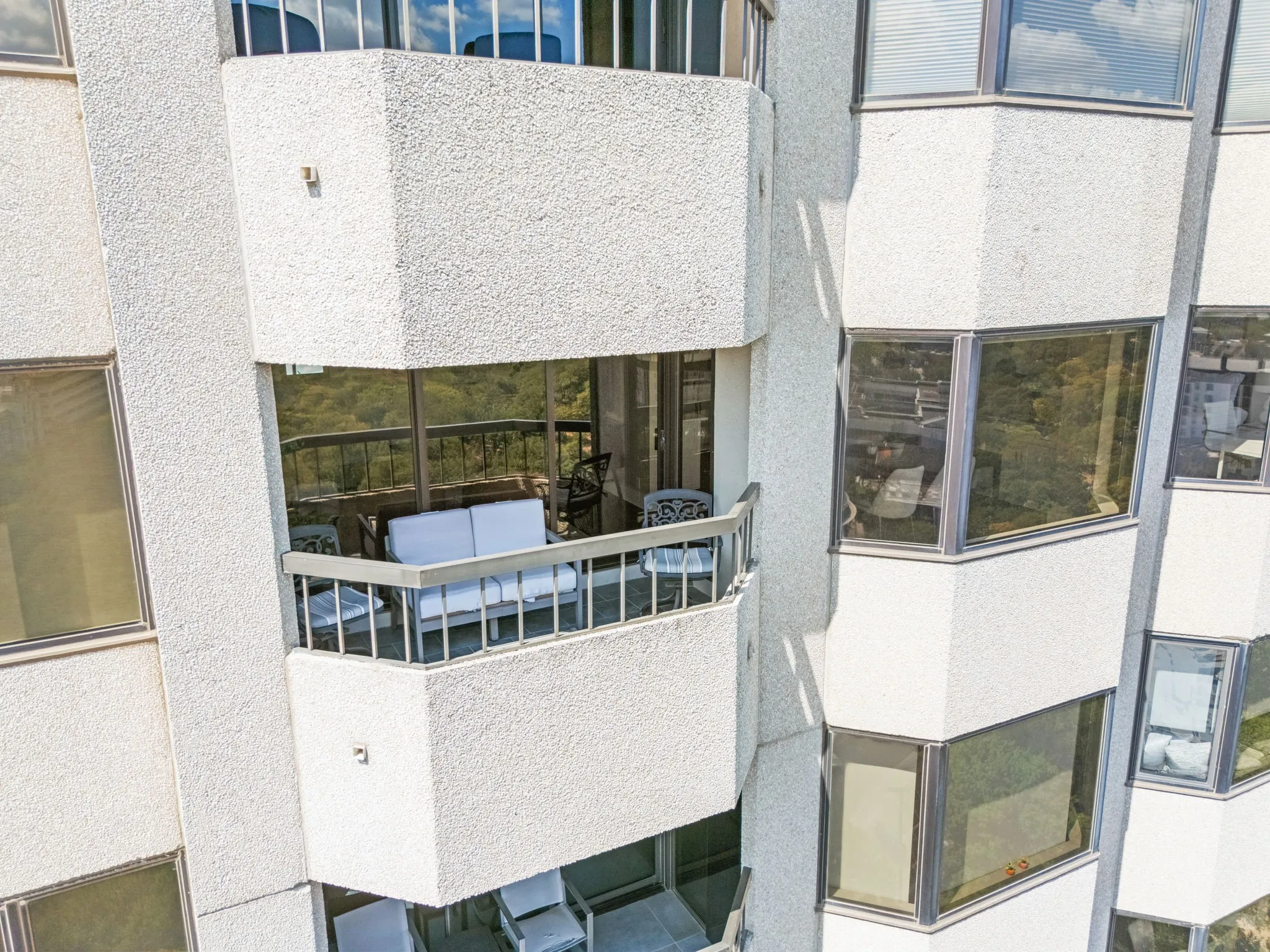 An exterior view showcasing the expansive 19th-floor balcony and its elevated vantage point.