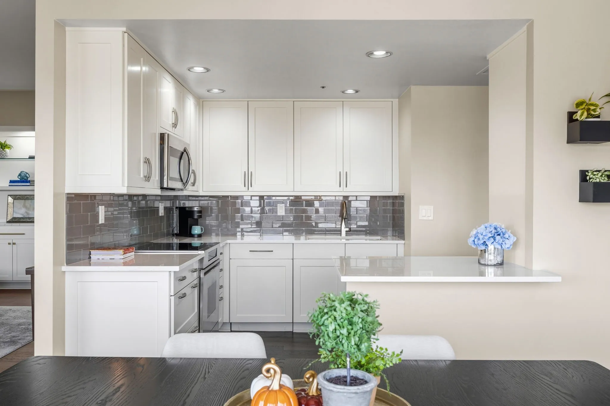 Thoughtfully designed, the kitchen opens seamlessly to the dining area, while the breakfast bar provides additional serving space, perfect for entertaining friends and enjoying memorable dinners together.