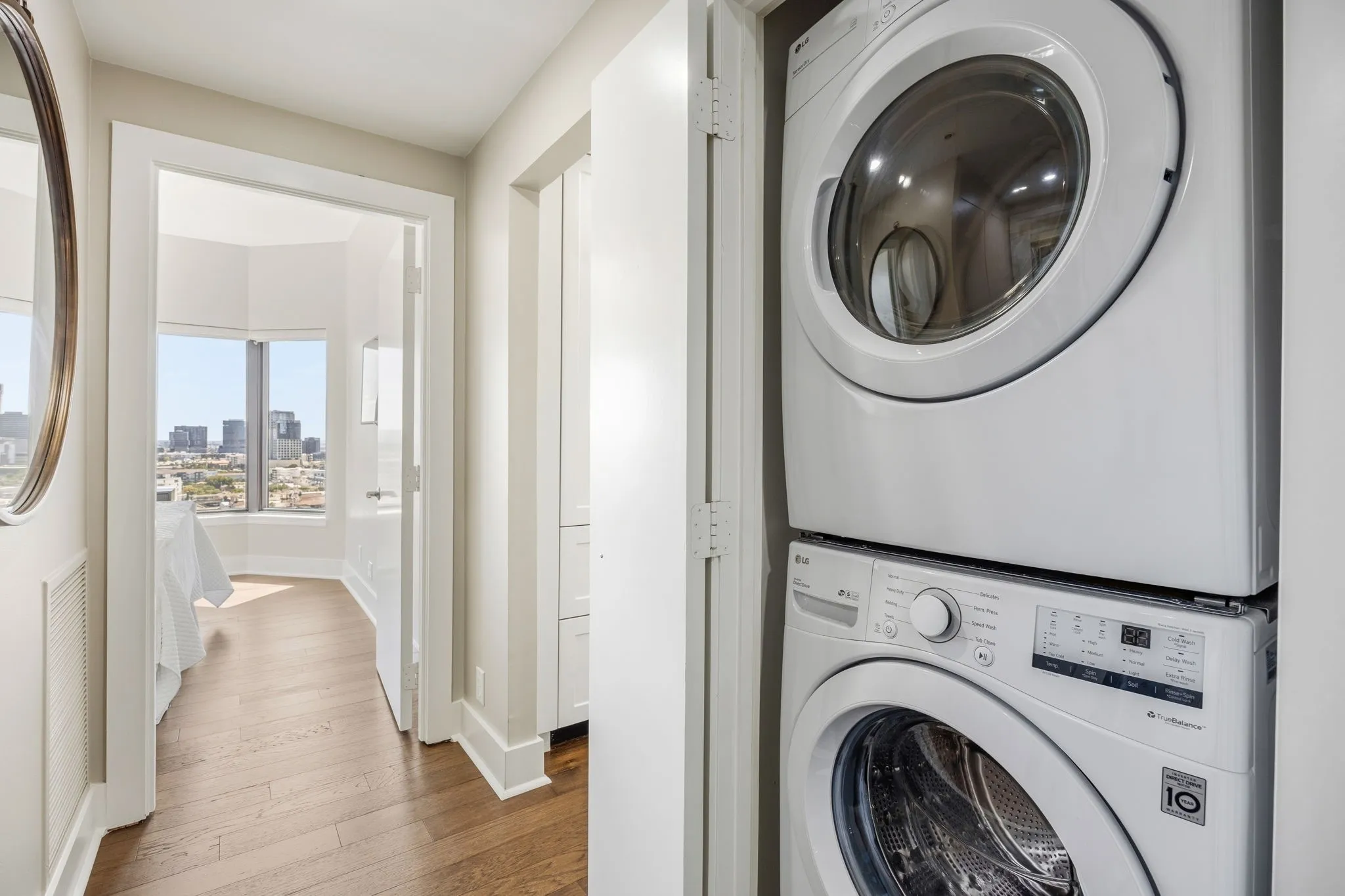 A conveniently located hall closet provides easy access to the stacked washer and dryer, keeping laundry essentials tucked neatly away yet readily accessible.