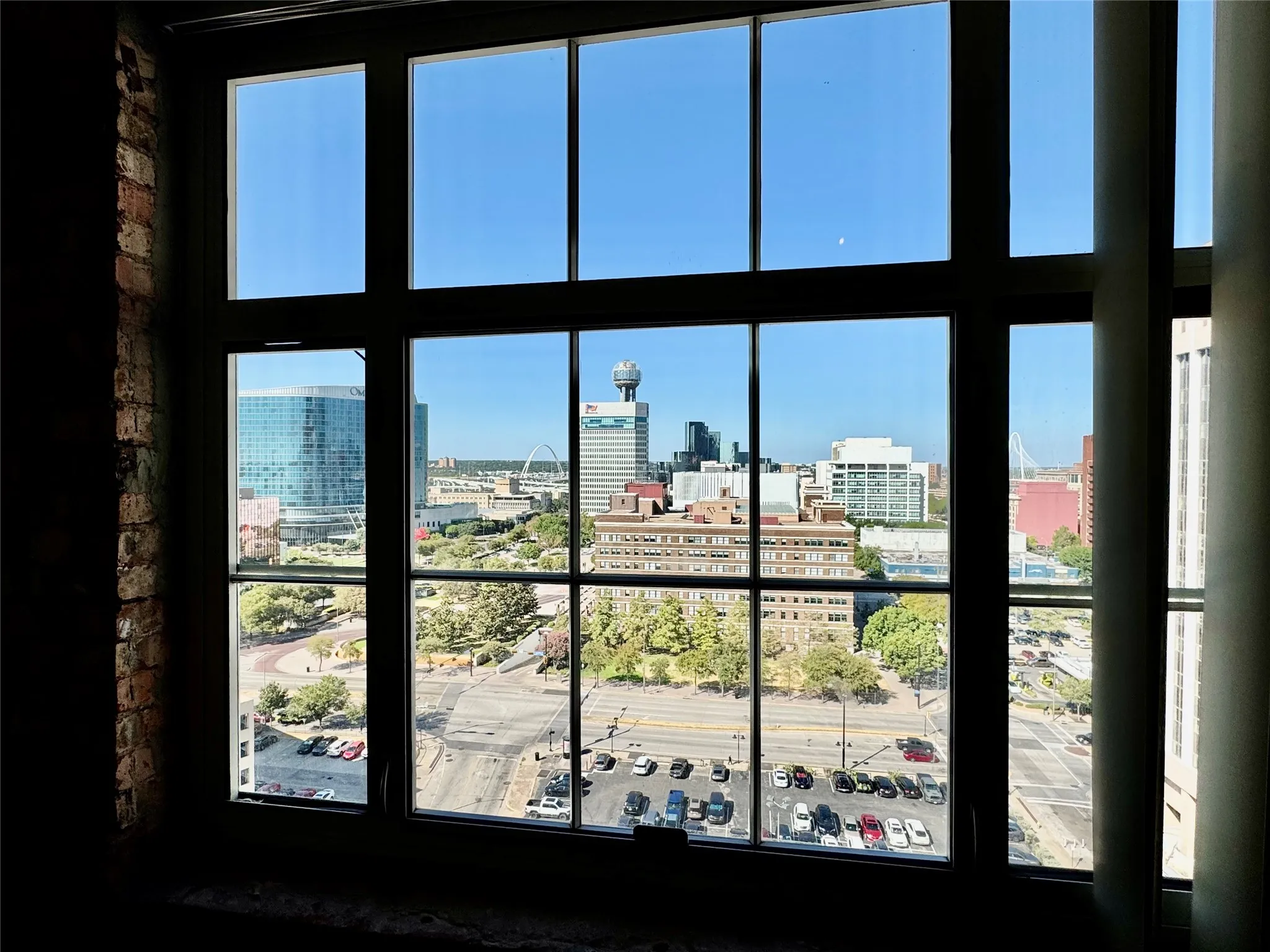 Large multi-pane window framing a cityscape