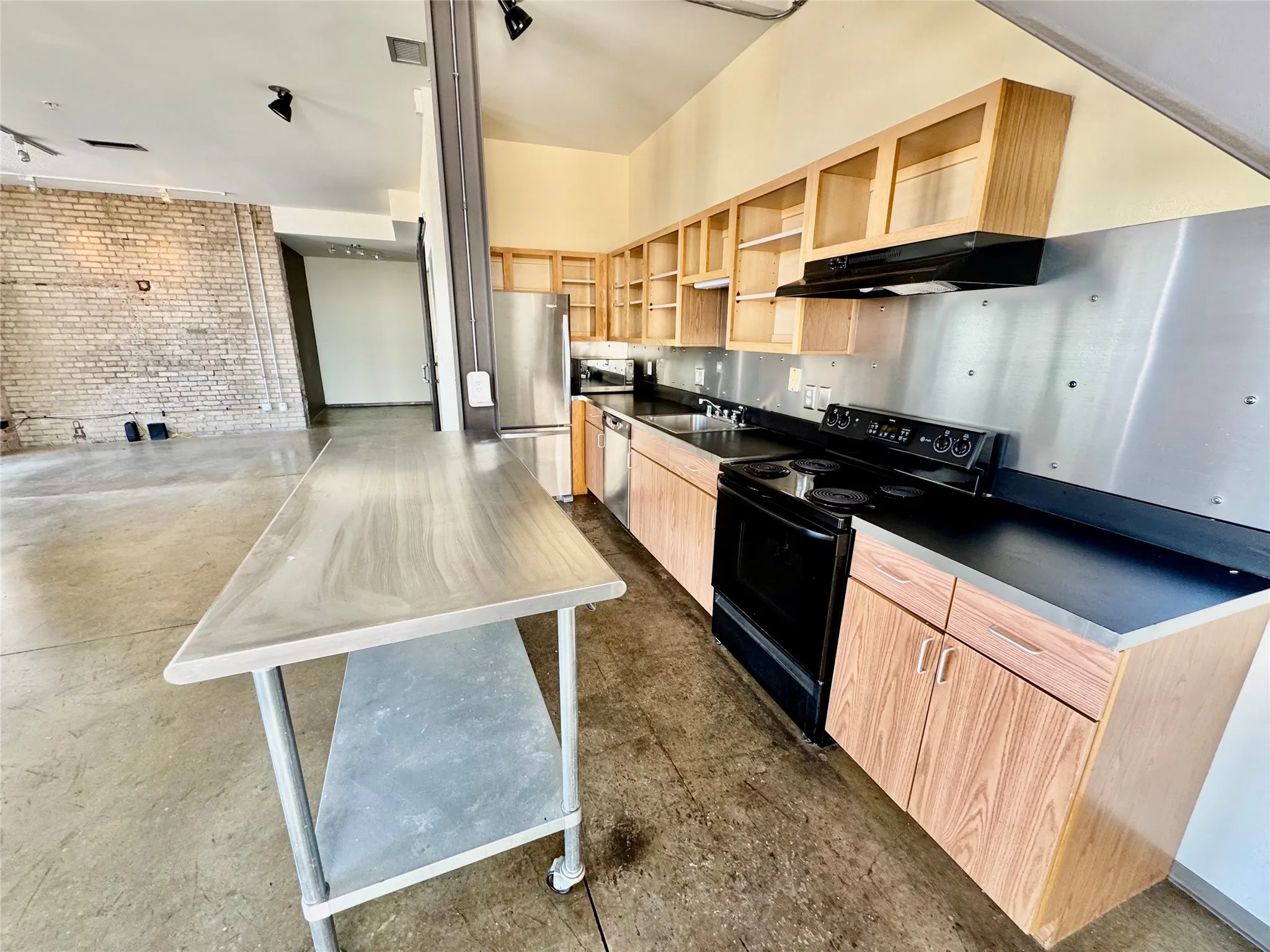 Exposed brick wall with concrete flooring