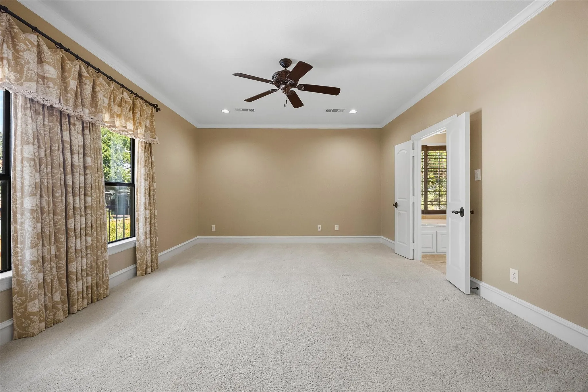 Recessed lighting, crown molding, double pane windows, ceiling fan, and carpet flooring