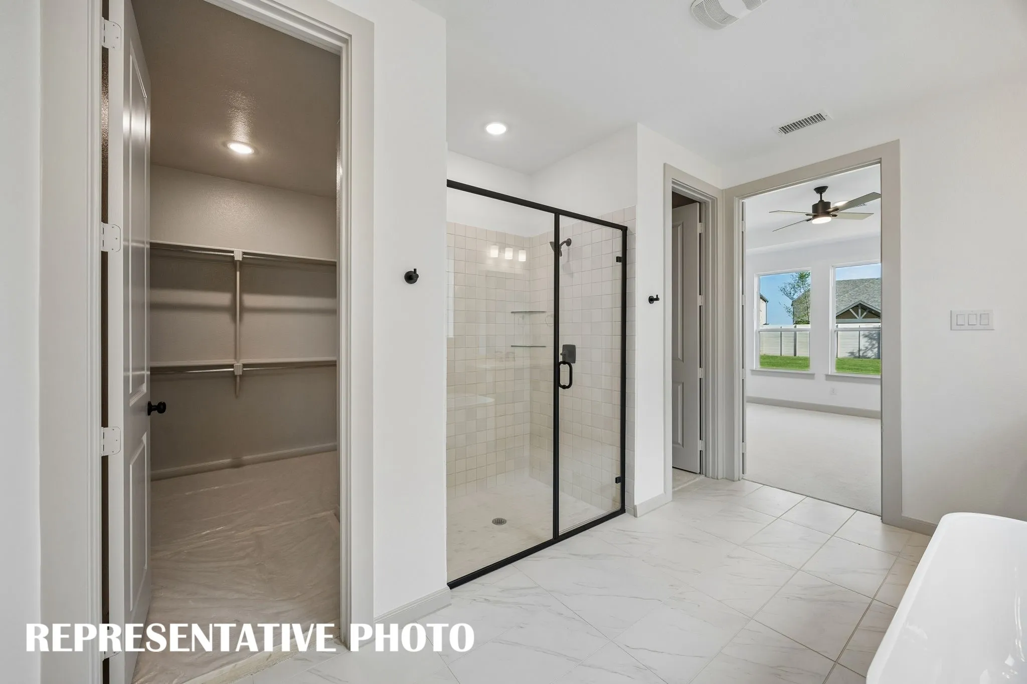 Featuring a free standing tub with spacious walk in shower and his & hers closets, you will love this fantastic owner's bath!  REPRESENTATIVE PHOTO