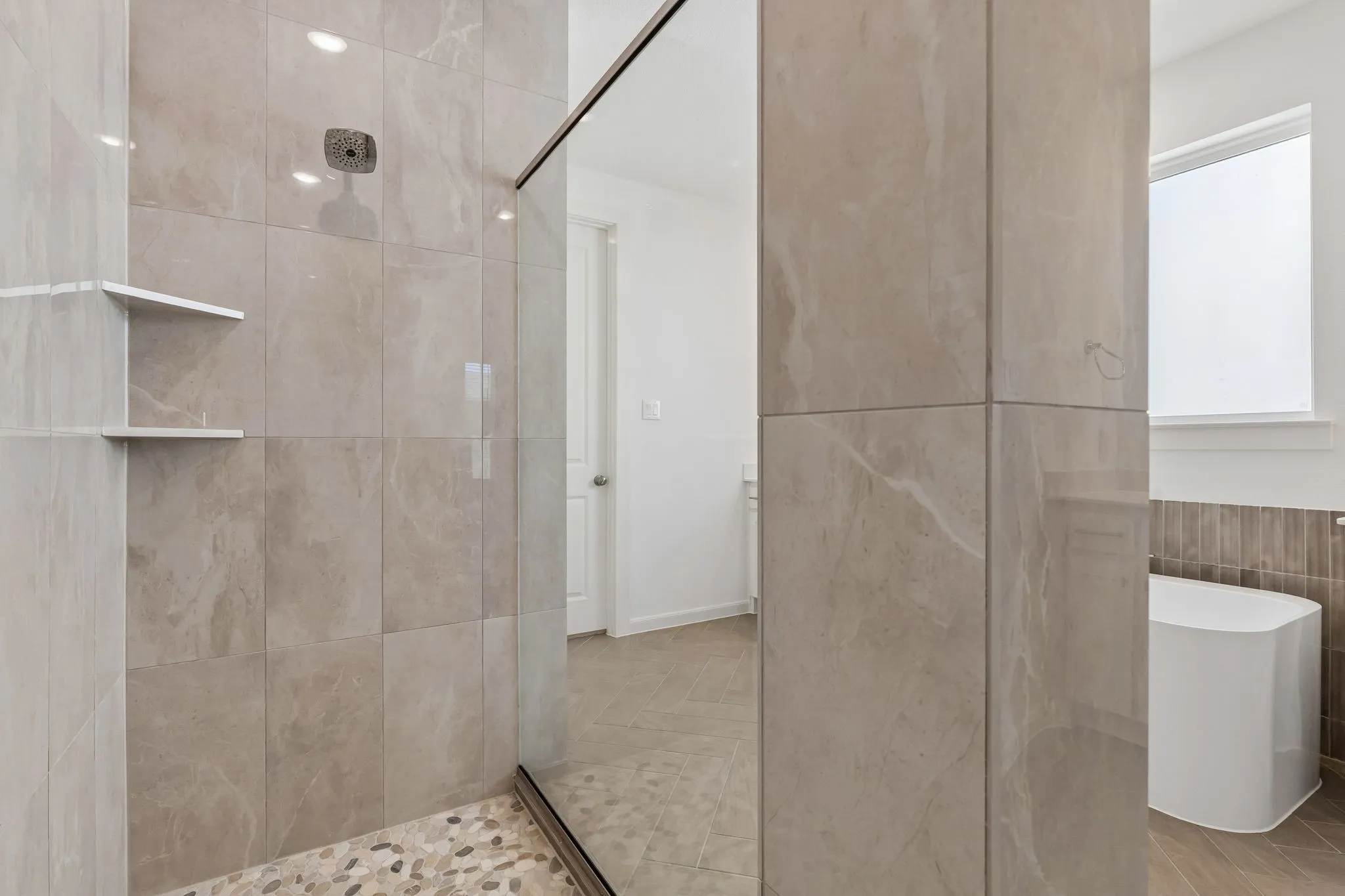 This dream owner's bath features a spacious walk in shower with drying area!