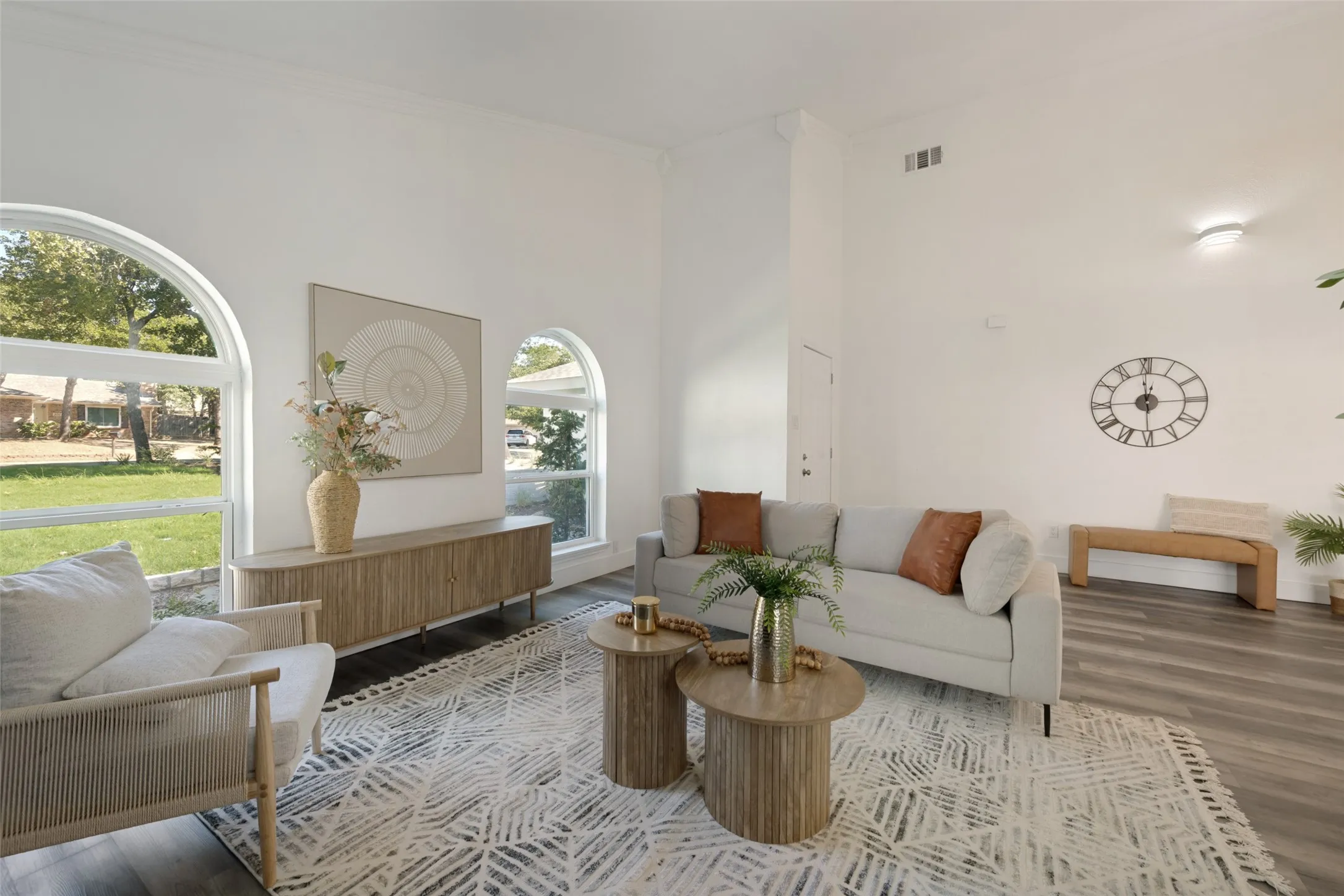 Vaulted ceilings, wood-finish flooring, and arched windows