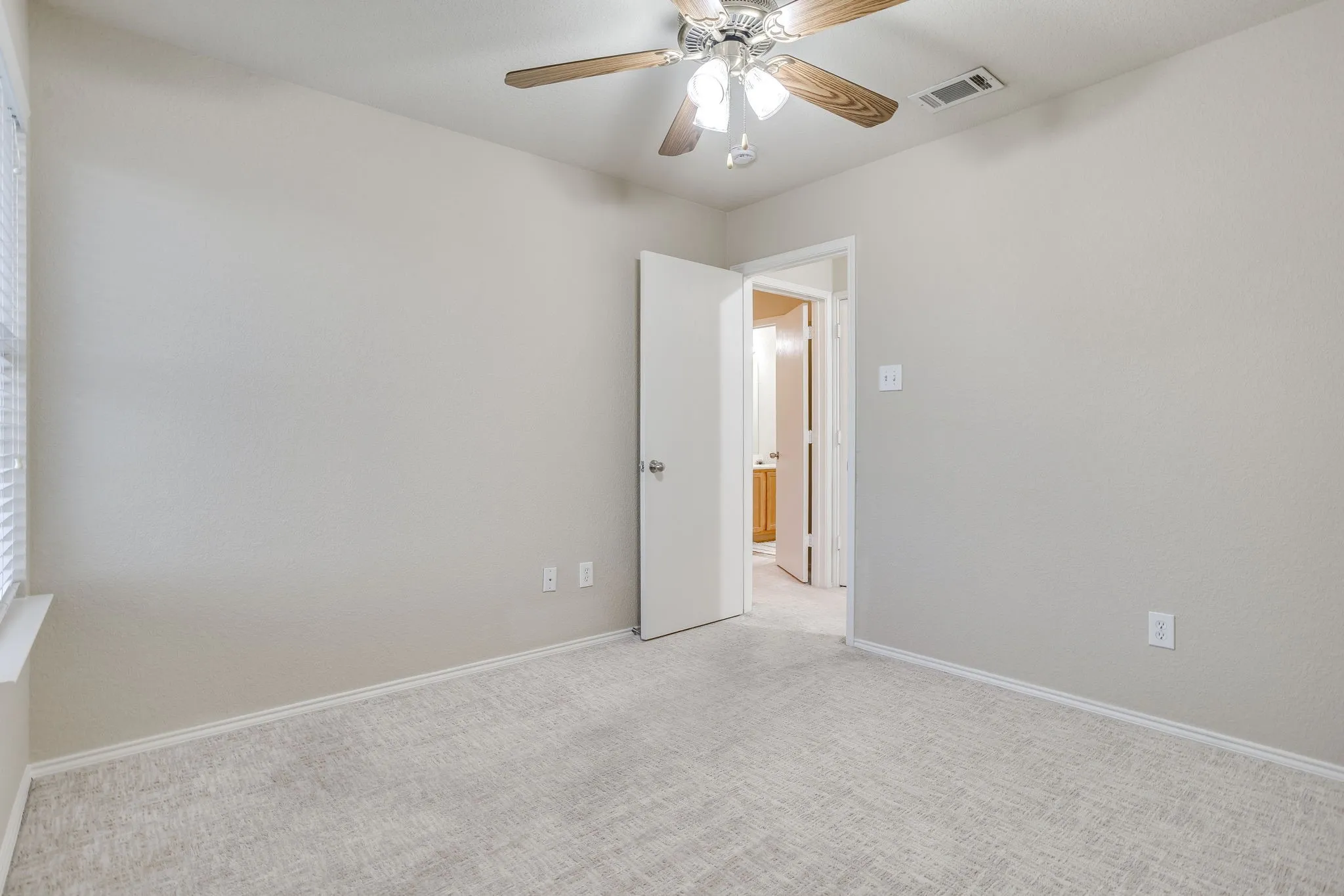 Neutral tone walls with light-colored carpeting