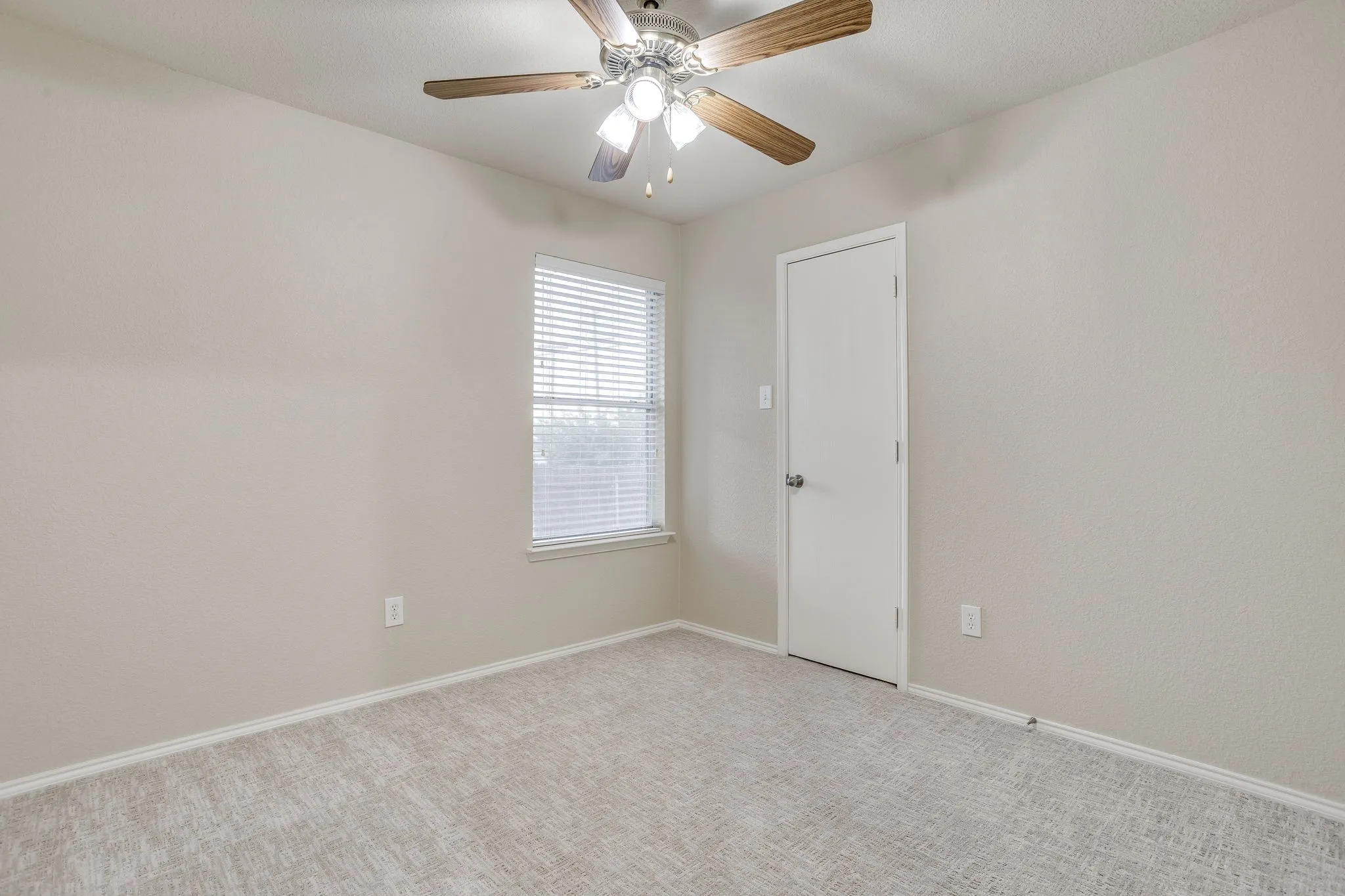 Neutral-toned walls complement the light-colored carpet, providing a versatile interior