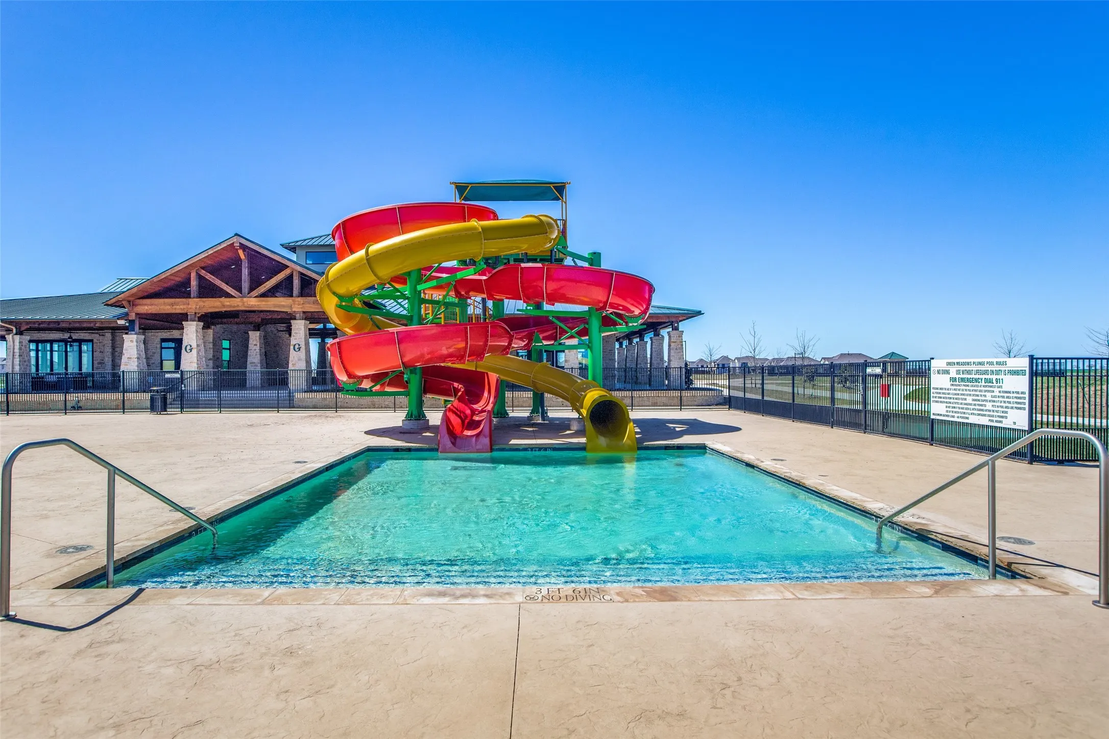 Enjoy resort-style living at the community pool, featuring exciting twisting water slides and a spacious swimming area perfect for cooling off and having fun.