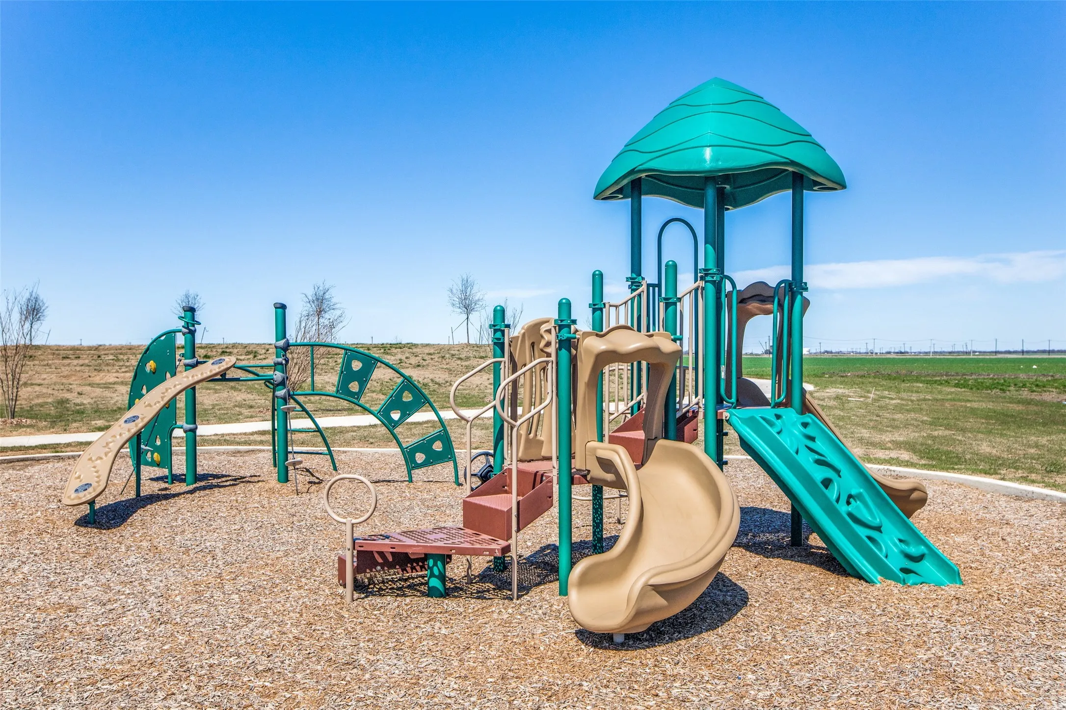 A fun-filled community playground offers slides, climbing features, and plenty of space for kids to play and explore. Surrounded by open green space, this inviting neighborhood amenity is perfect for outdoor fun and enjoying beautiful Texas days close to home.