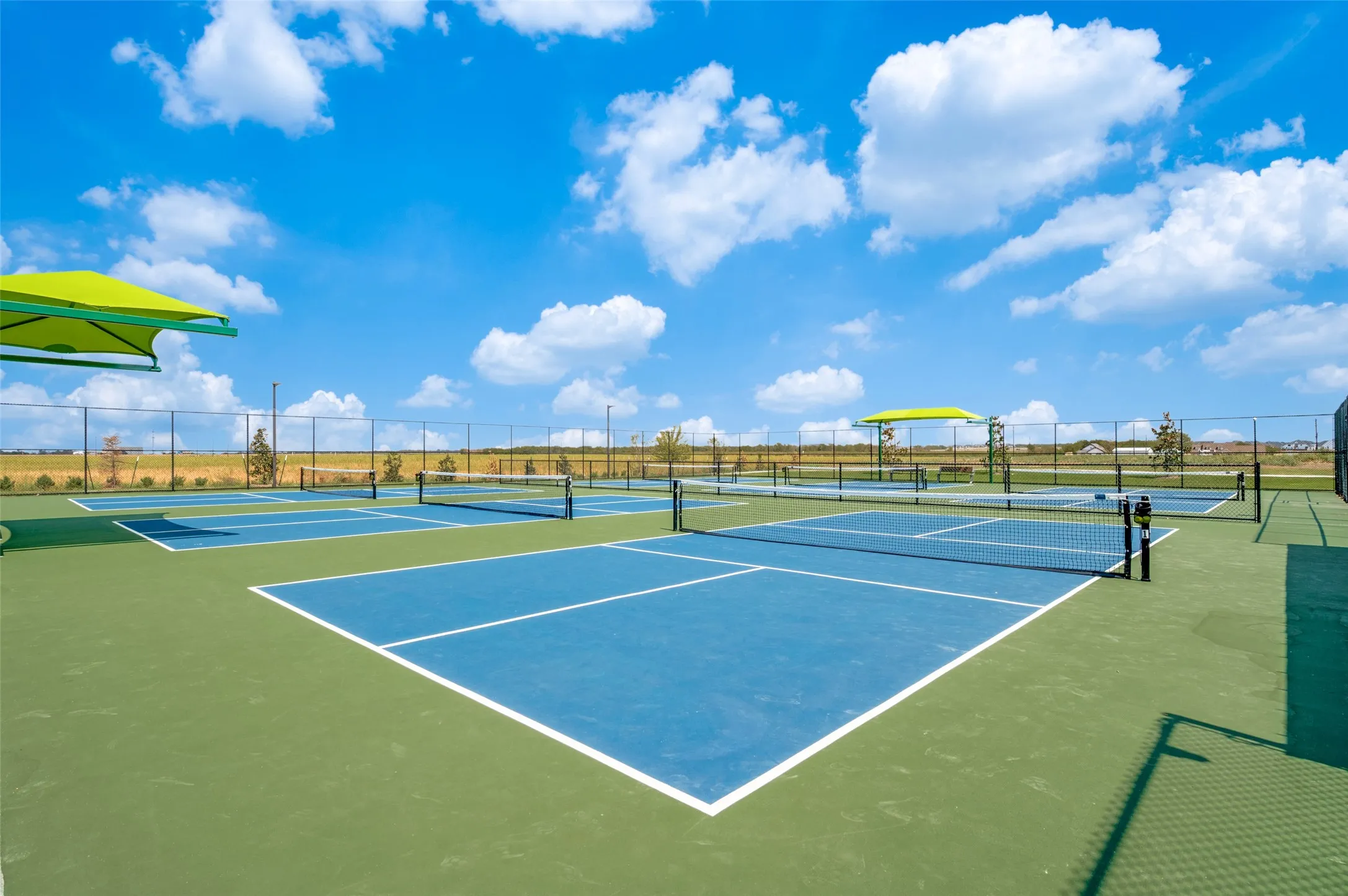 Enjoy an active lifestyle with beautifully maintained community pickleball courts, offering plenty of space for friendly matches and competitive play. With multiple courts and shaded seating areas, this inviting amenity is perfect for staying active, socializing with neighbors, and enjoying the outdoors.