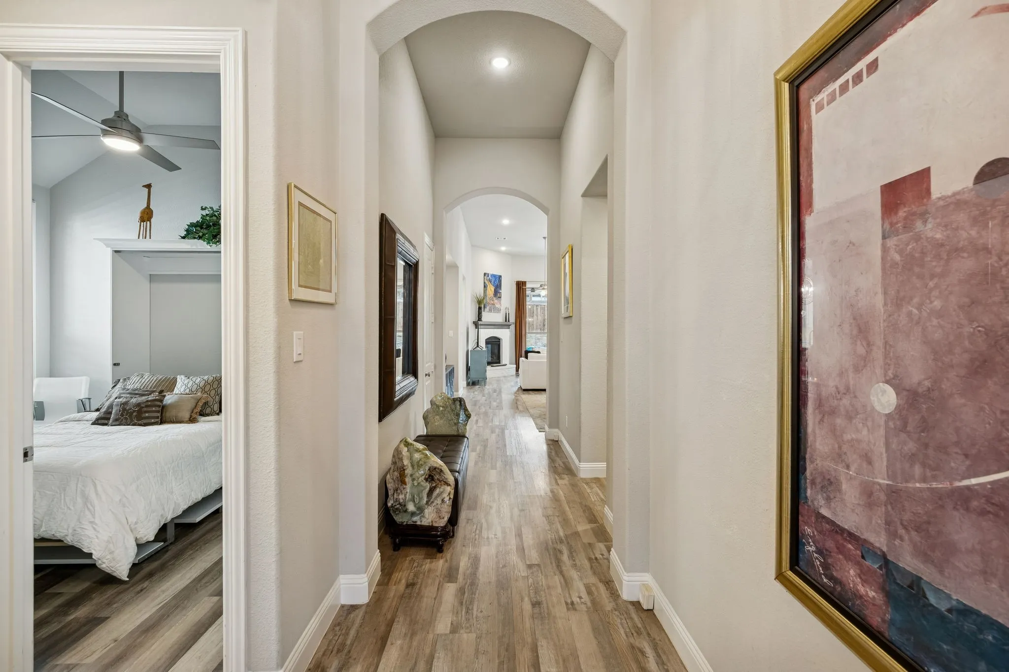 hallway leading to living area with bedroom visible on the left