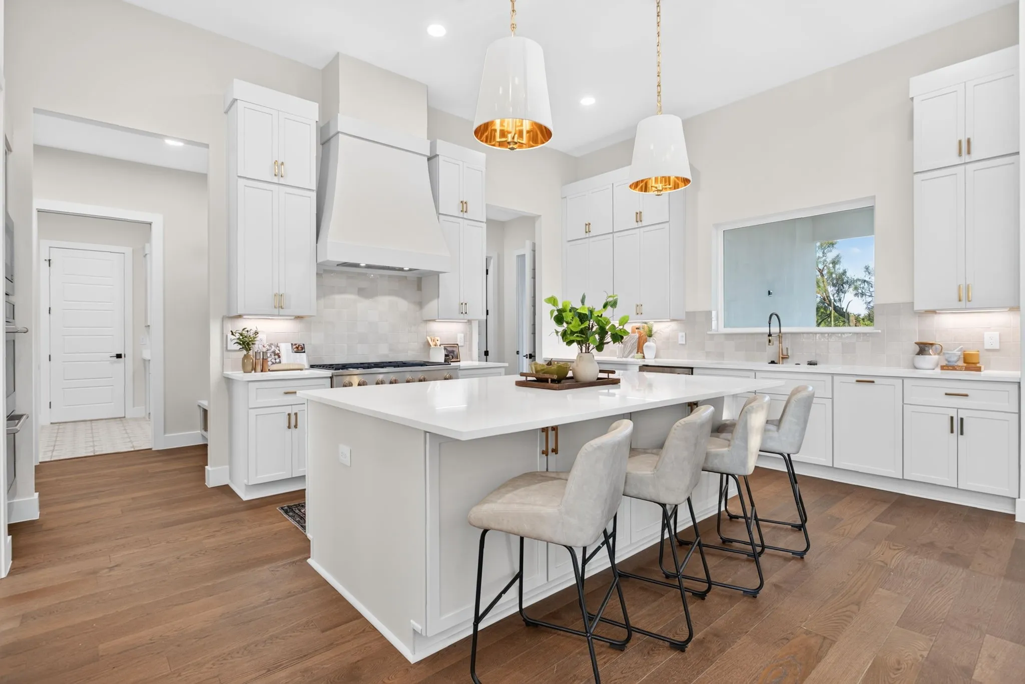 Cabinets are a soft cream color - love the hardware and under-cabinet lighting. LOVE the custom vent hood.
