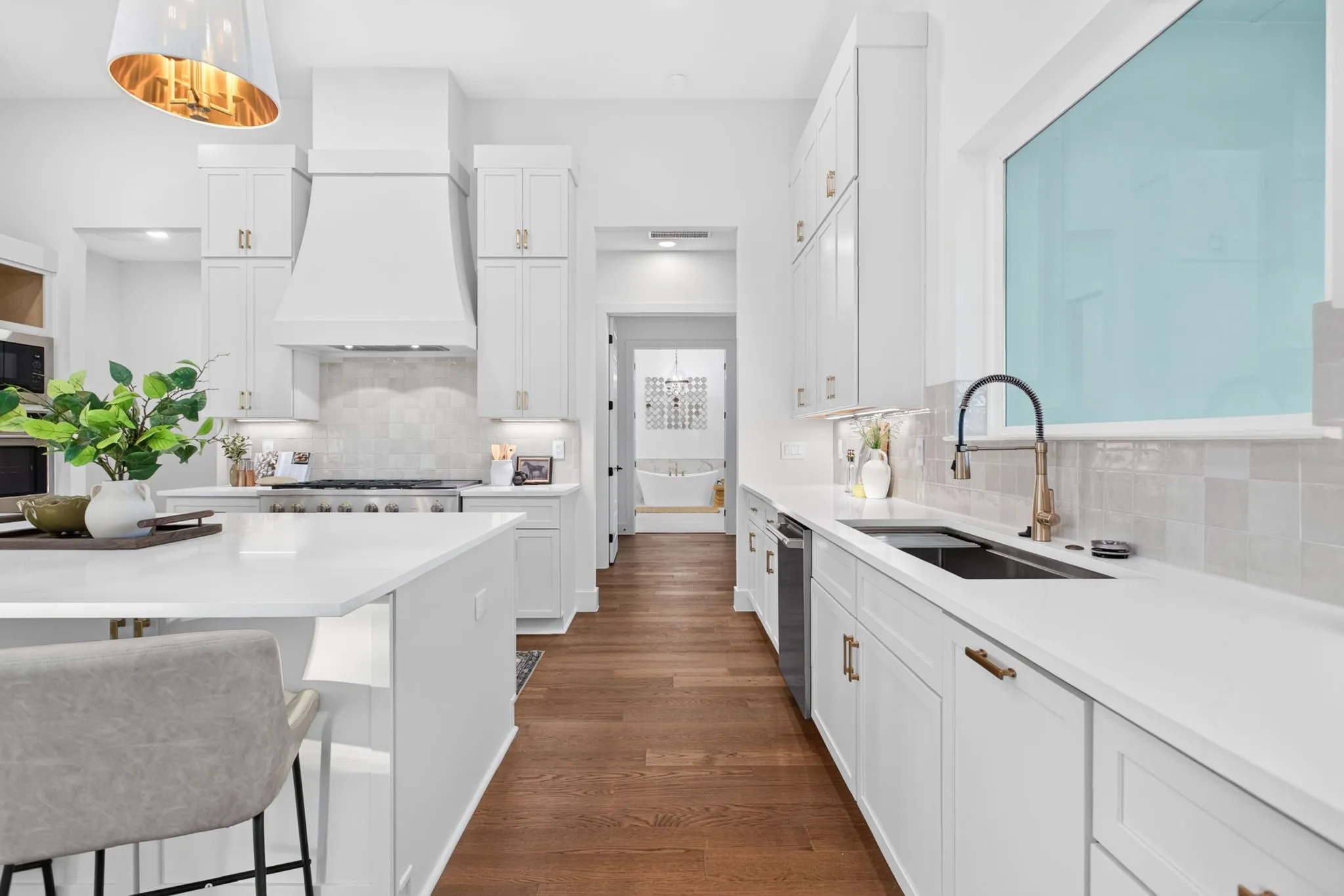 The sink is single basin, 45" long and boasts a built-in rinse tray, drying rack and a push-button garbage disposal. Primary suite beyond can be closed off via double doors.