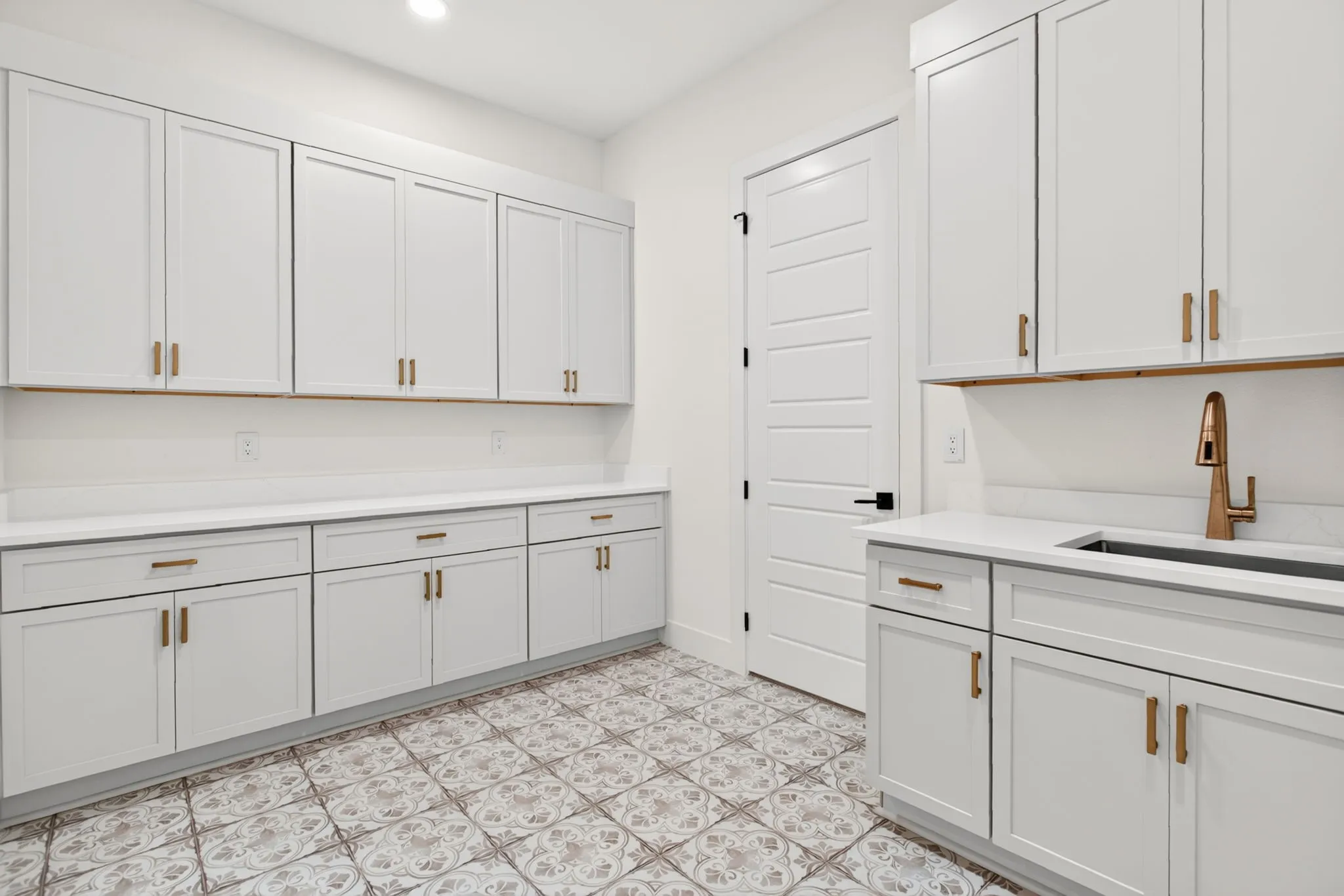 Giant laundry room with a sink and SO MUCH storage. Finally!