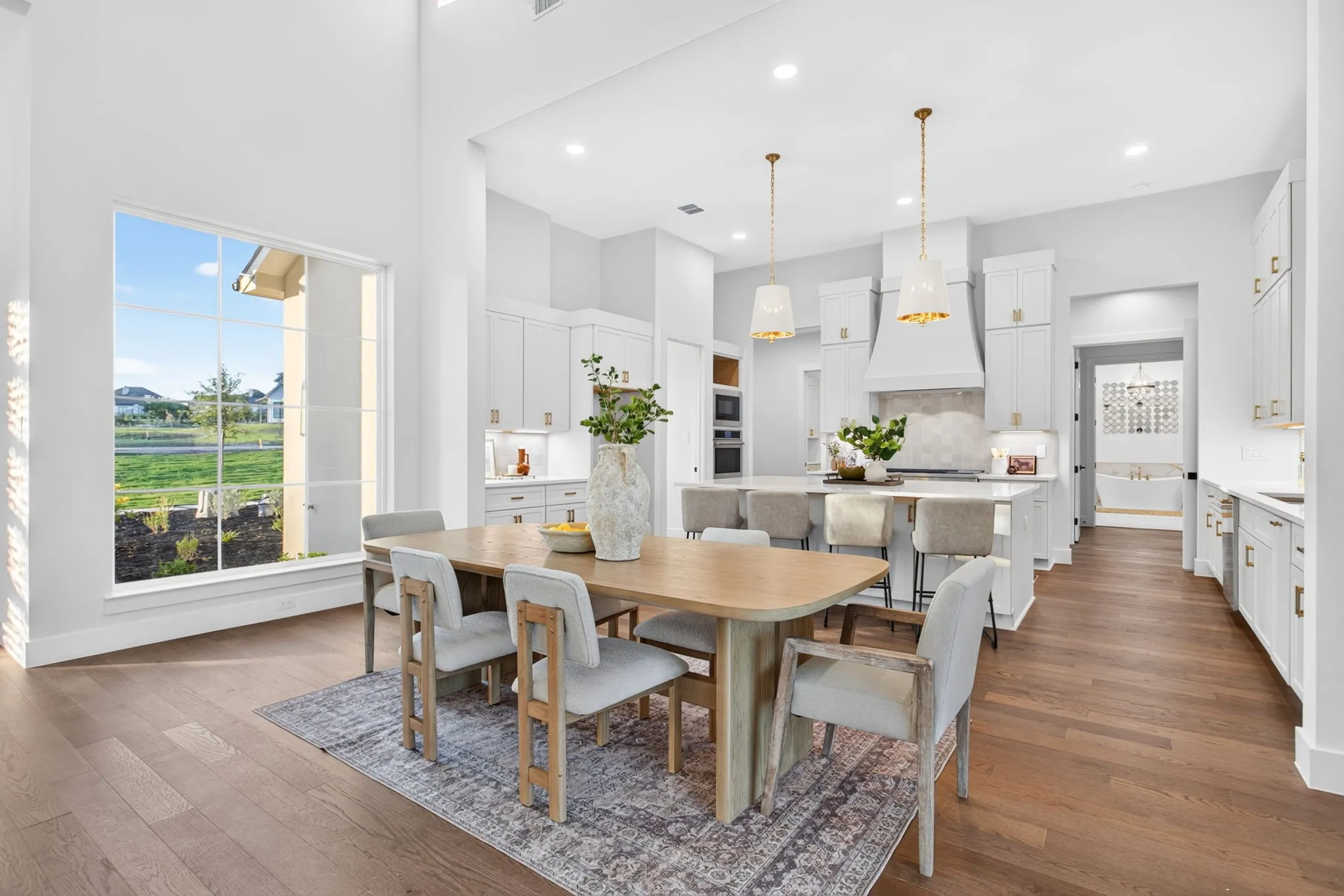 Dining space in advance of the kitchen. We all know formal dining typically doesn't happen anymore - now everyone is connected.