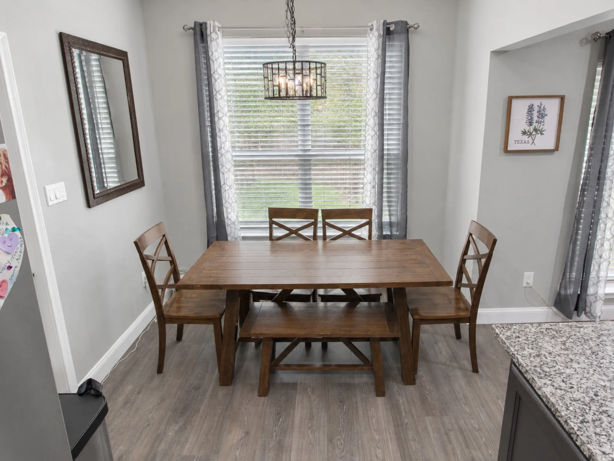 Wood-finish flooring throughout, complemented by light gray wall paint