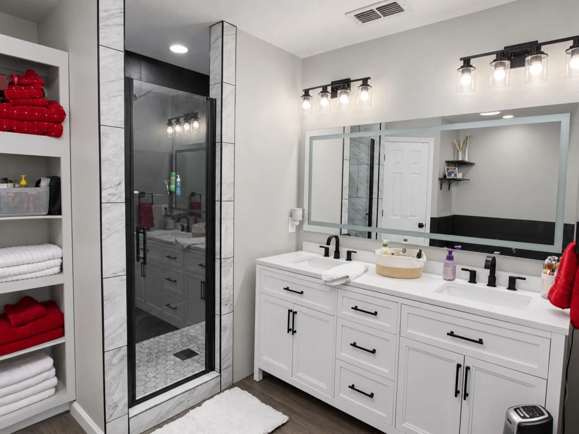 Dual vanity with white shaker cabinetry, quartz countertop, and matte black fixtures