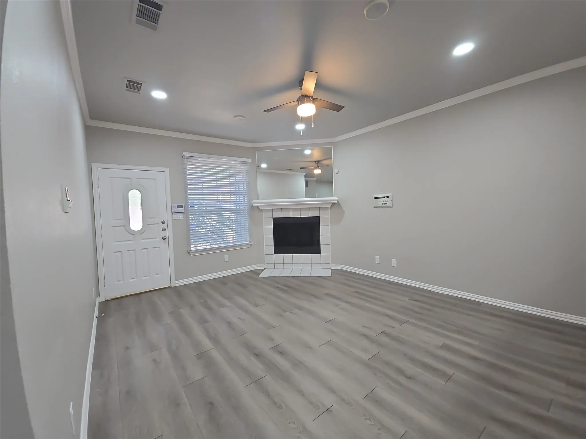 Wood-finish flooring, recessed lighting, and a ceiling fan