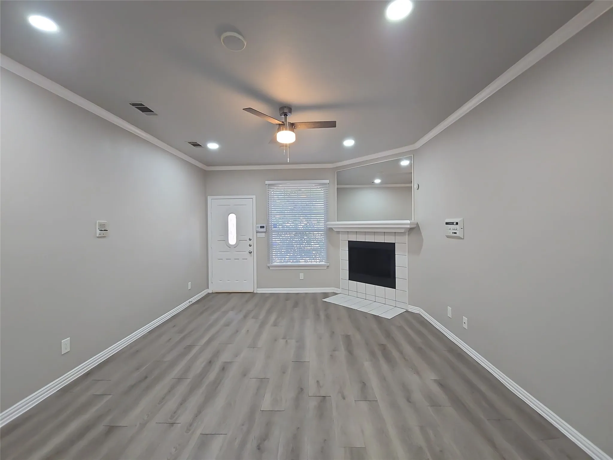 Wood-finish flooring, recessed lighting, and a ceiling fan