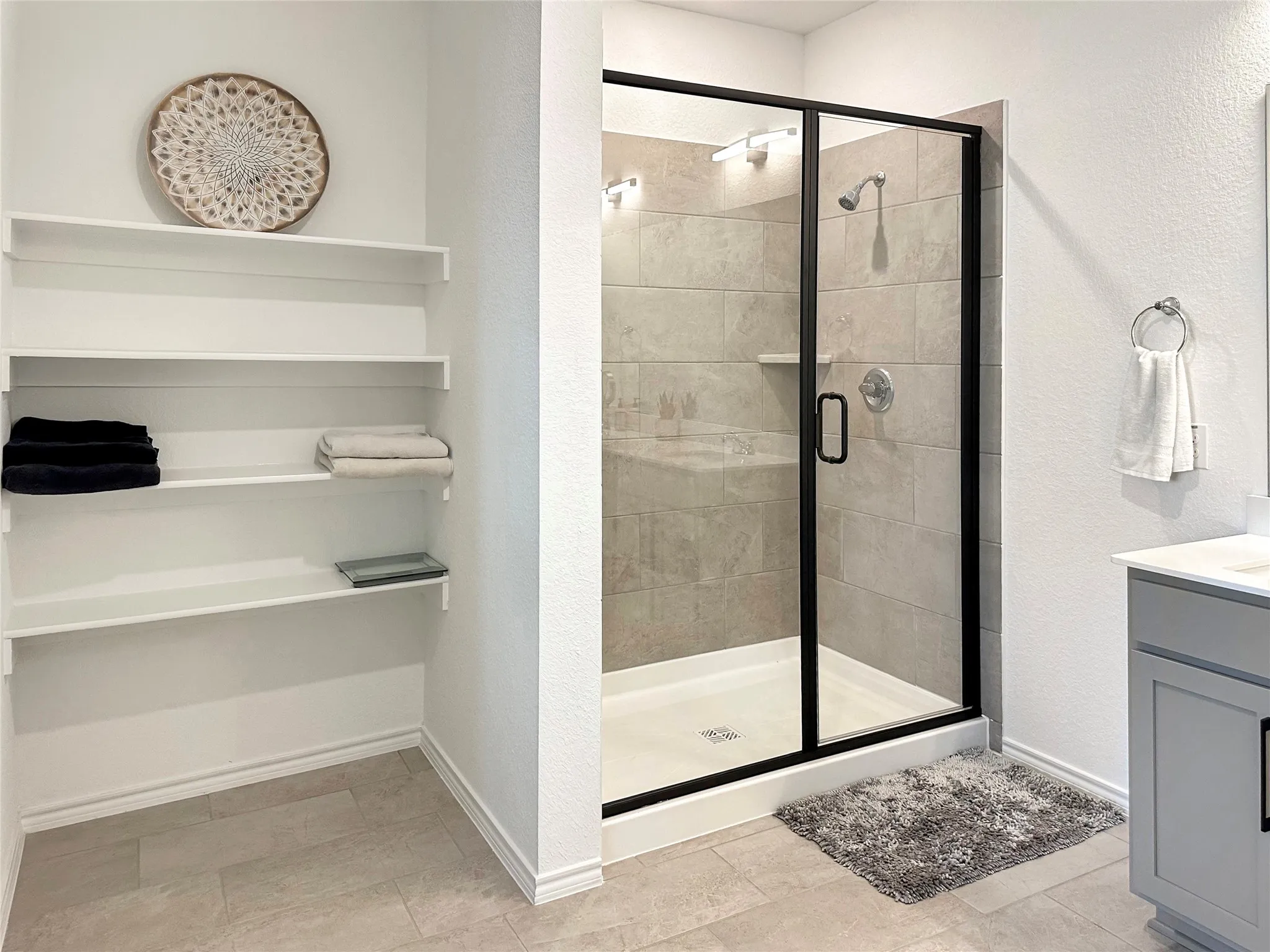 Bathroom featuring vanity and a shower with shower door
