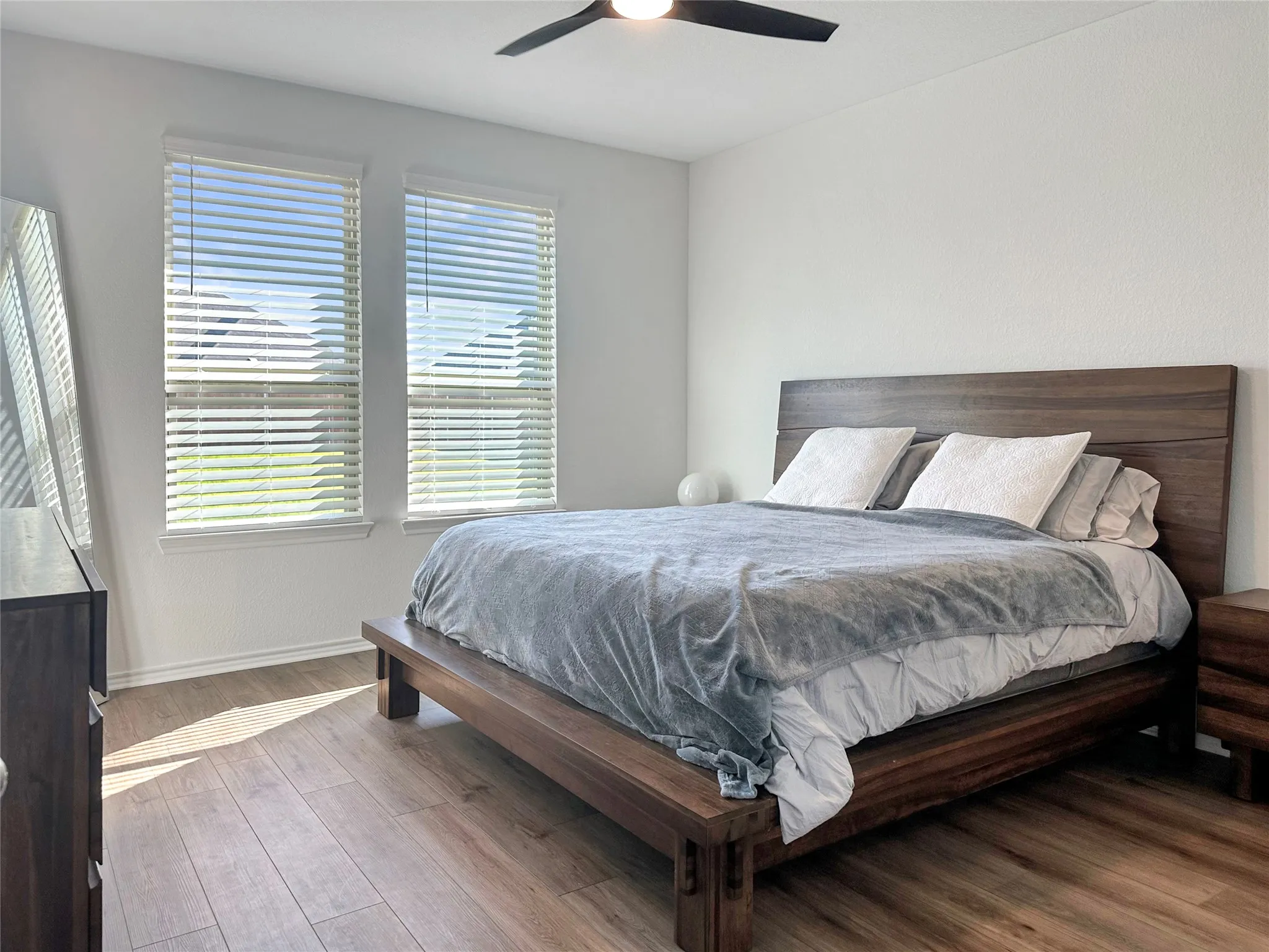 Bedroom with hardwood / wood-style floors and ceiling fan