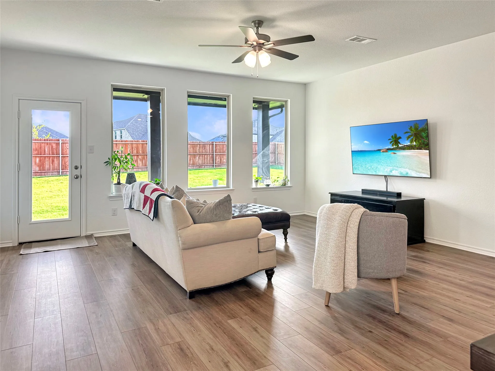 Living room featuring hardwood / wood-style floors and ceiling fan