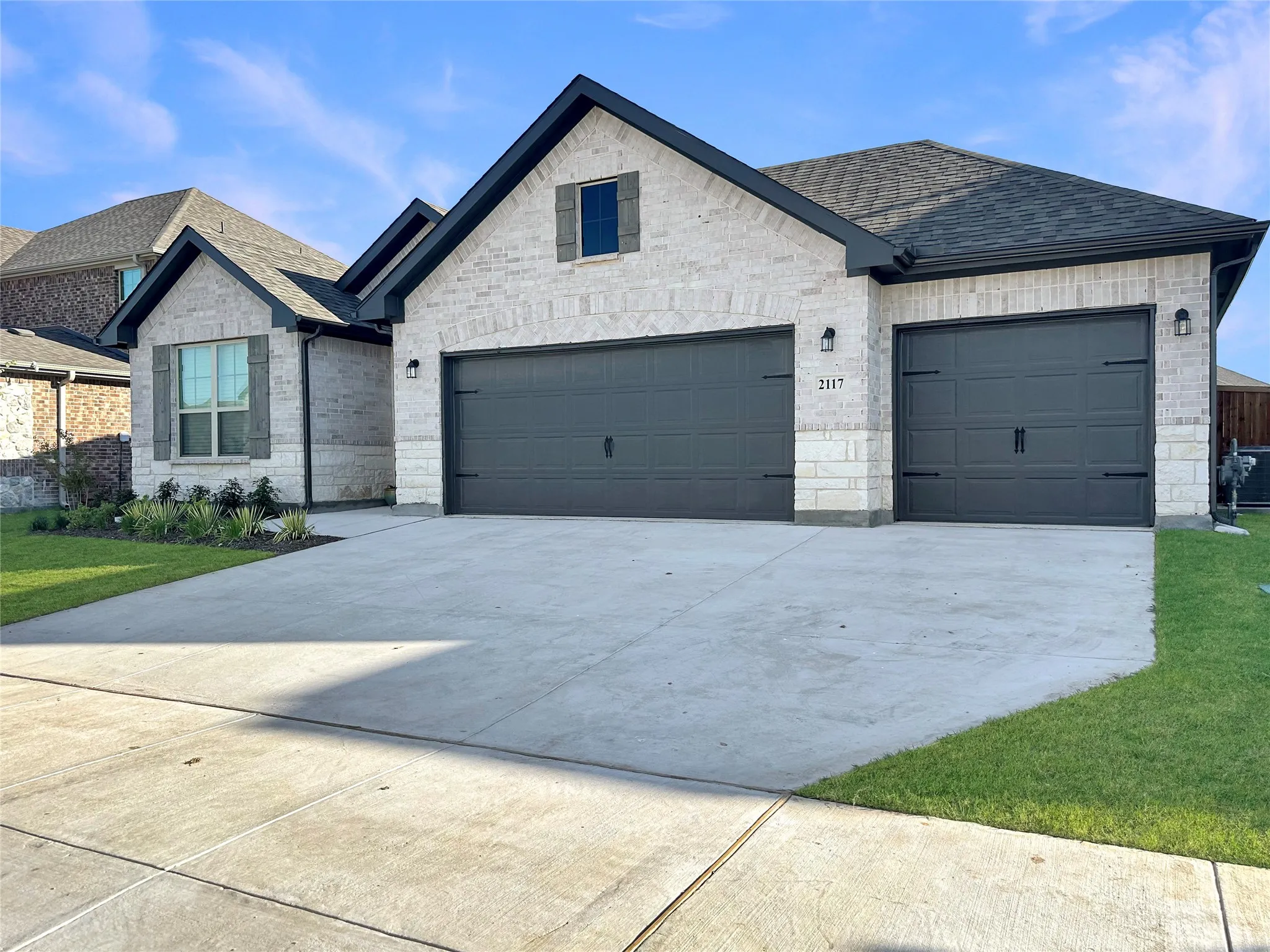 View of front of home featuring a garage and a front lawn
