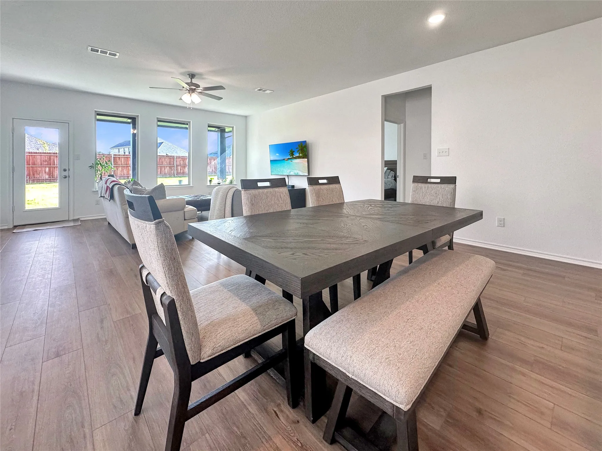 Dining room with ceiling fan and hardwood / wood-style flooring