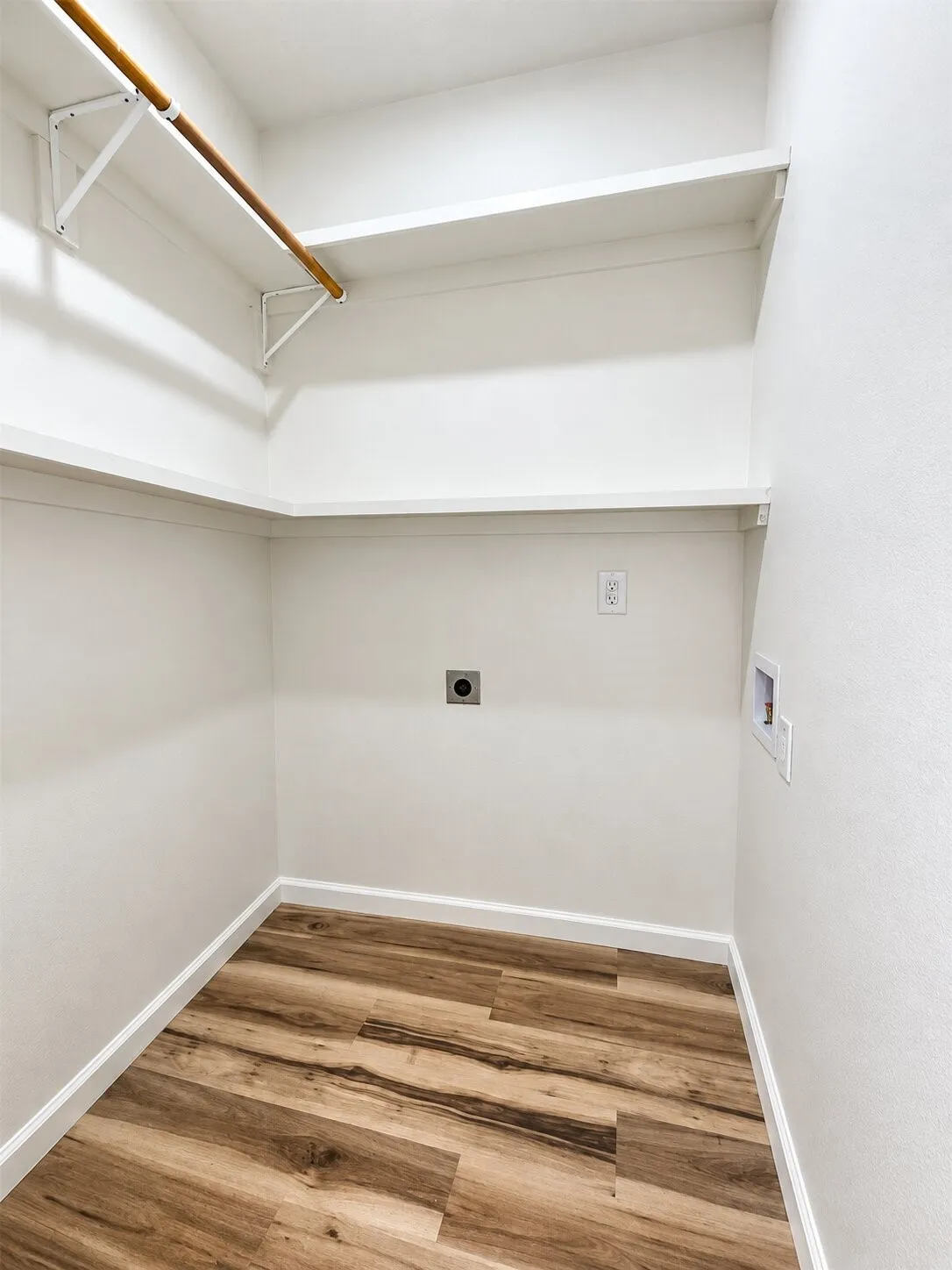 Built-in shelving, wood-finish flooring, and white painted walls