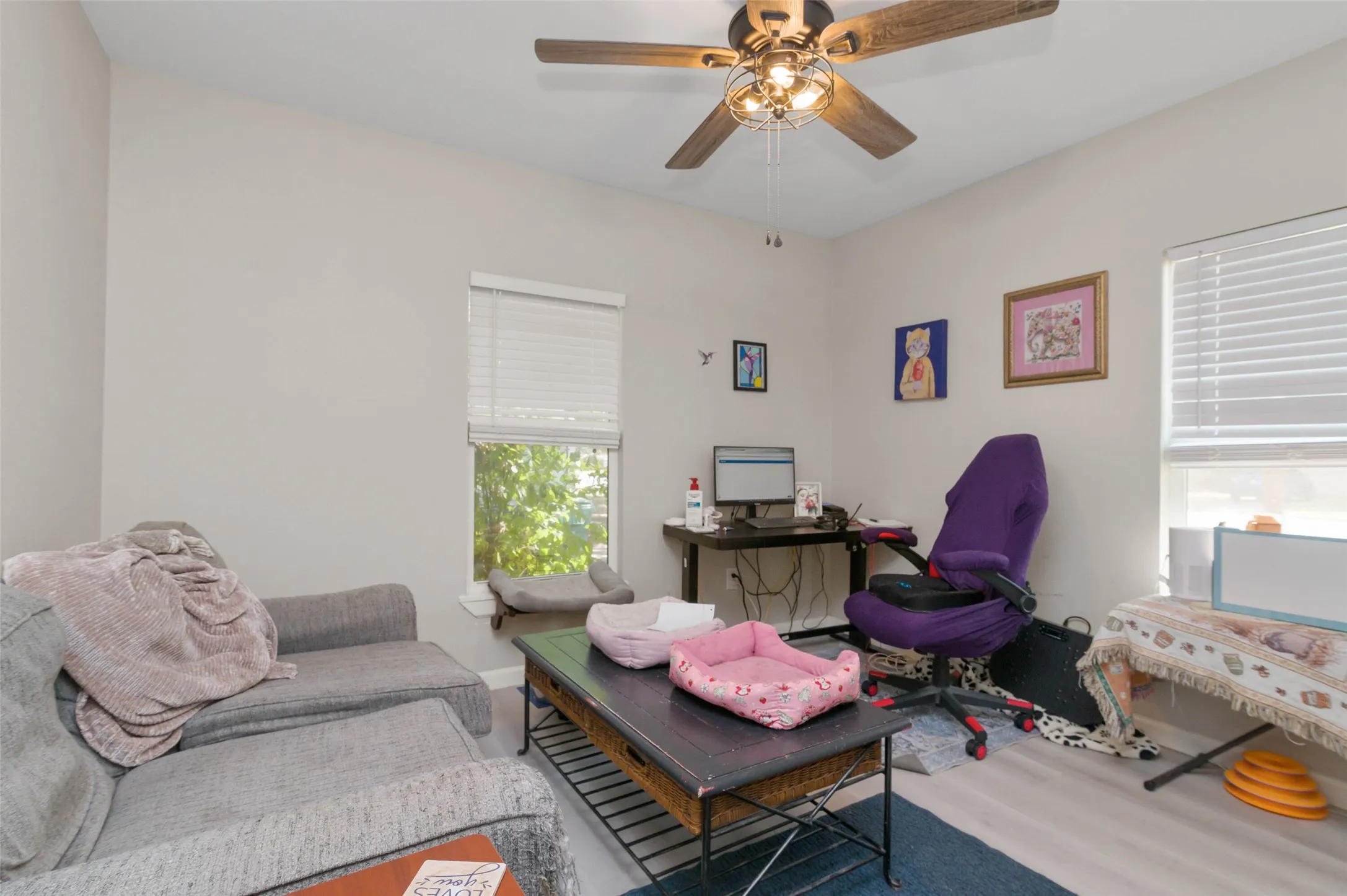 Bedroom with wood finished flooring and ceiling fan.