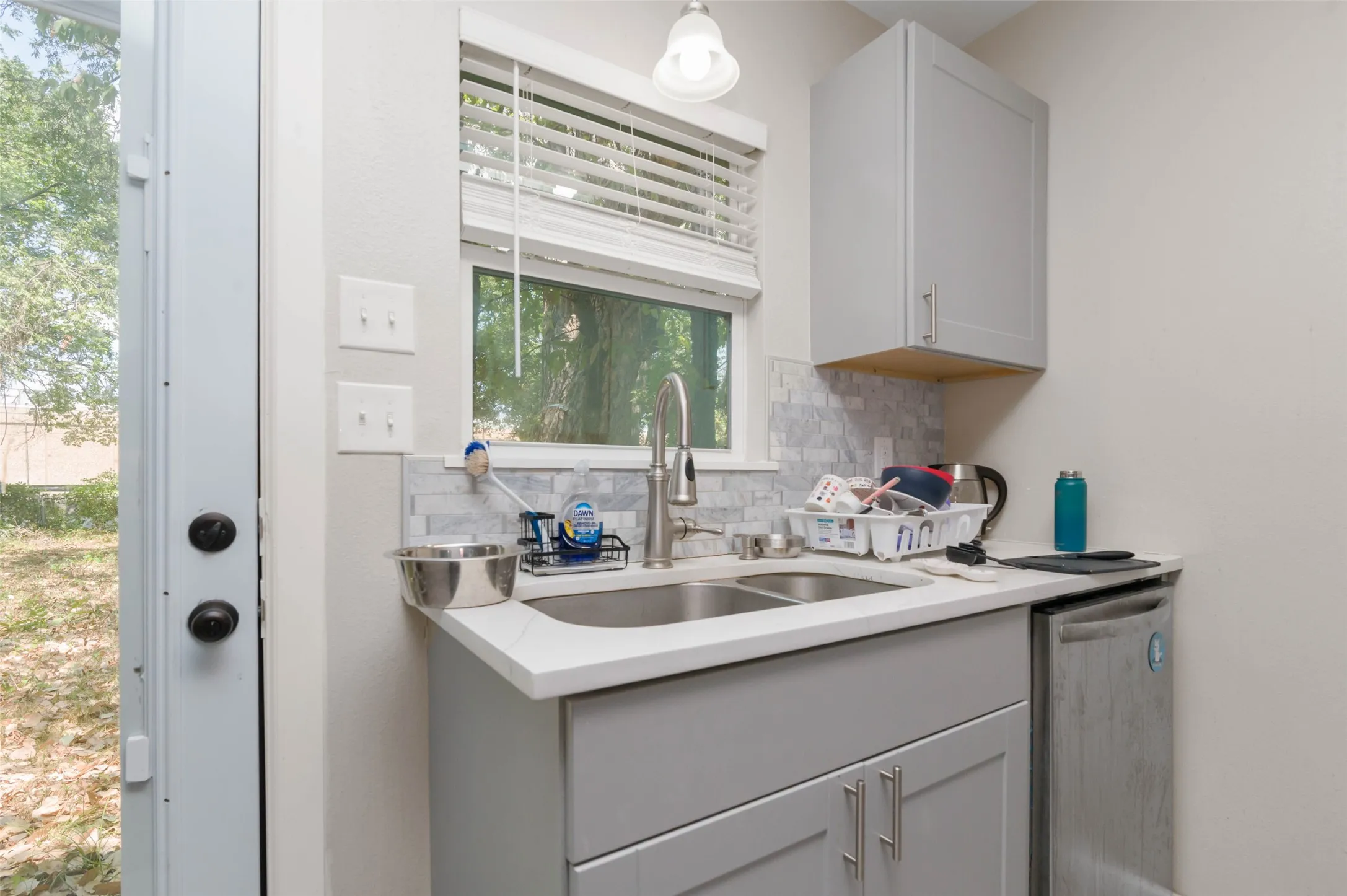 Nicely remodeled kitchen with custom backsplash and fresh cabinetry.