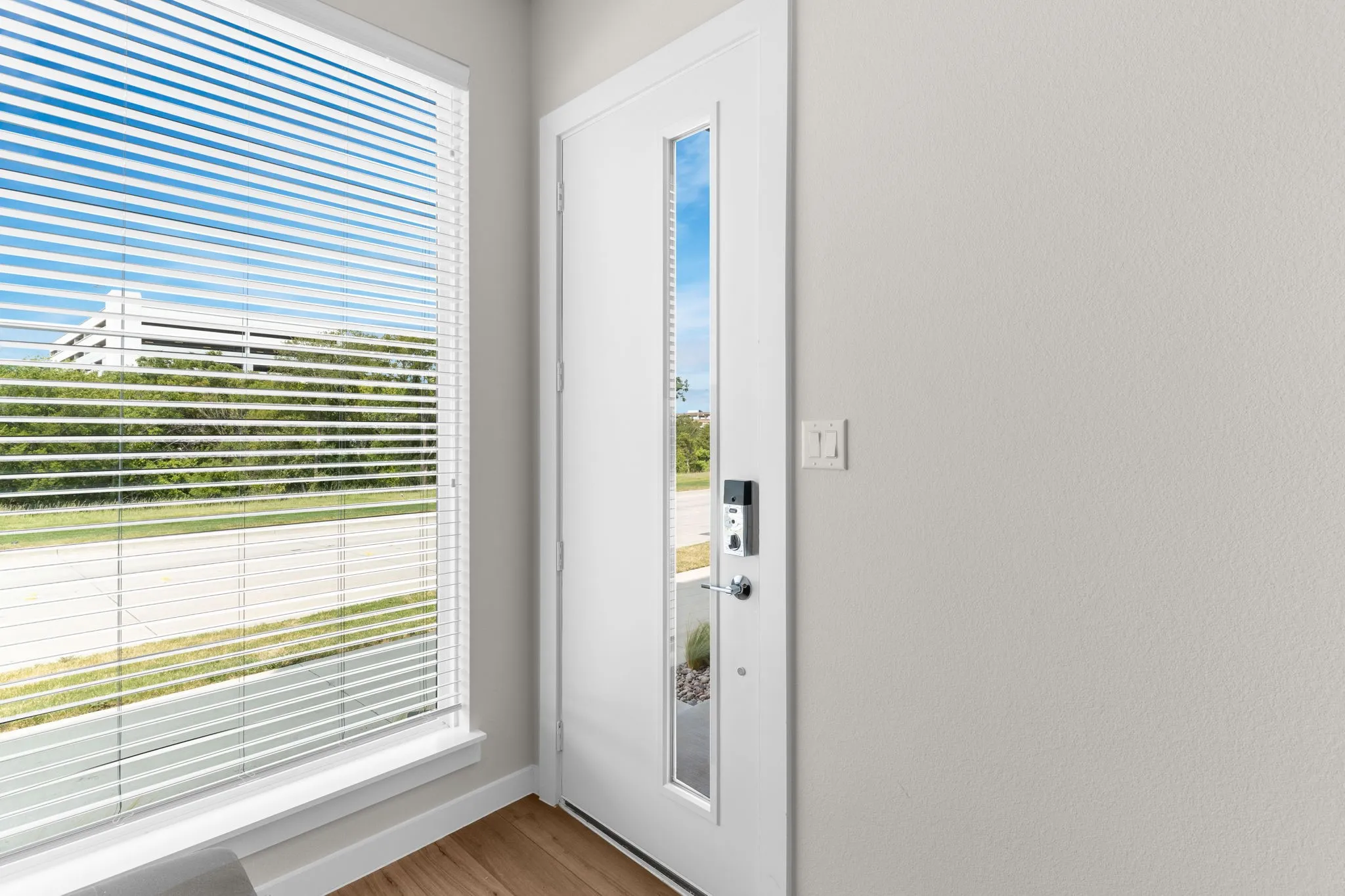 Contemporary entry door with an integrated window panel and smart lock system