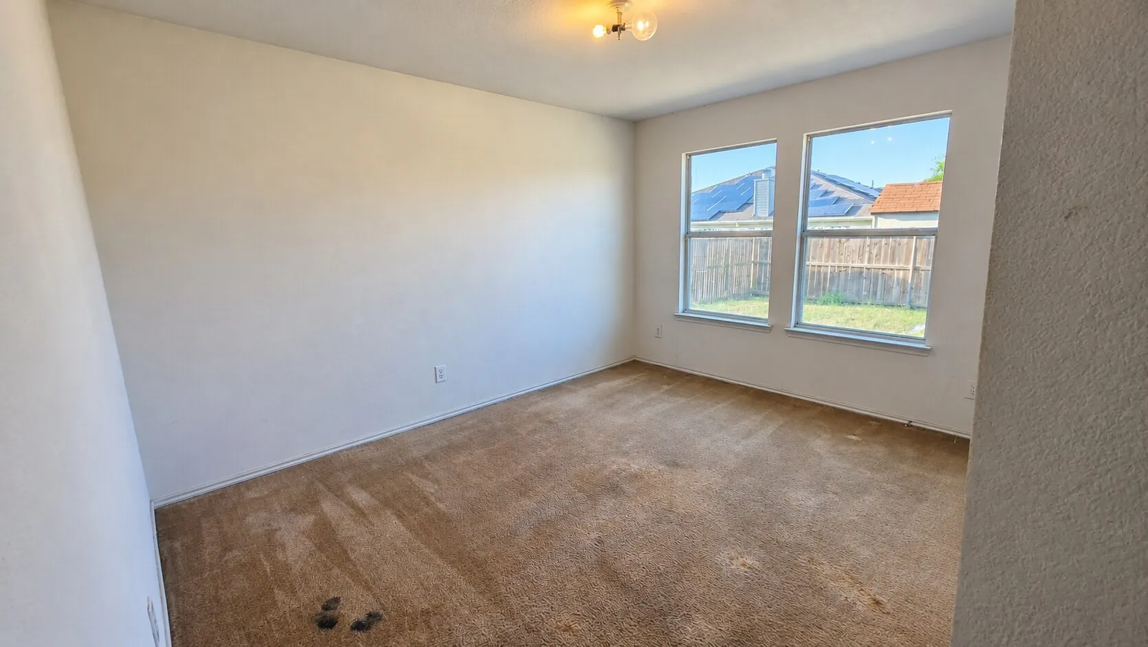 Recessed ceiling light fixture, two windows, wall-to-wall carpeting, and painted walls
